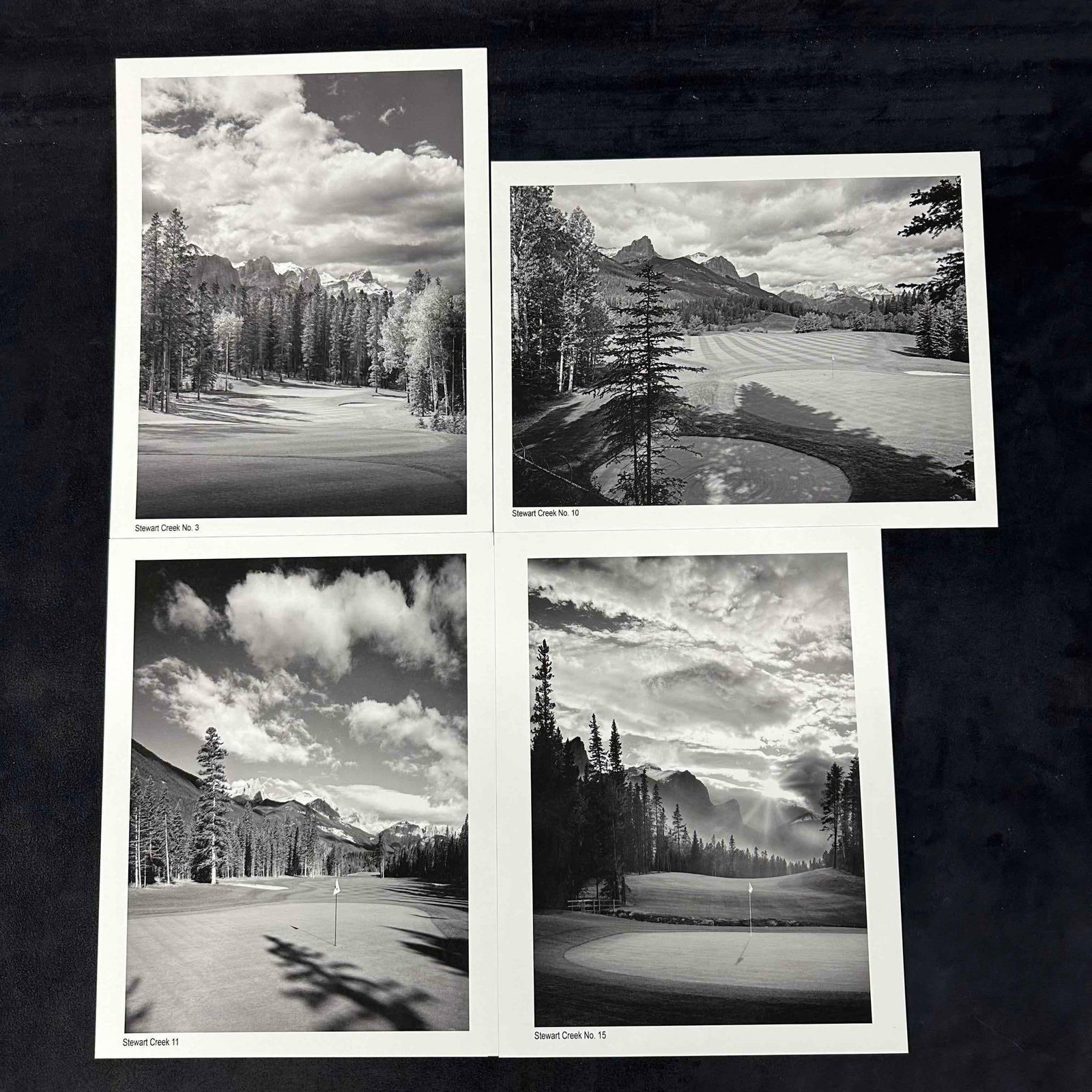 Stewart Creek Golf Course Black & White Set of Four Prints: Set of four black and white photographic prints featuring scenic views of Stewart Creek Golf Course, including holes No. 3, No. 10, No. 11, and No. 15. Each print highlights dramatic mountain backdrop