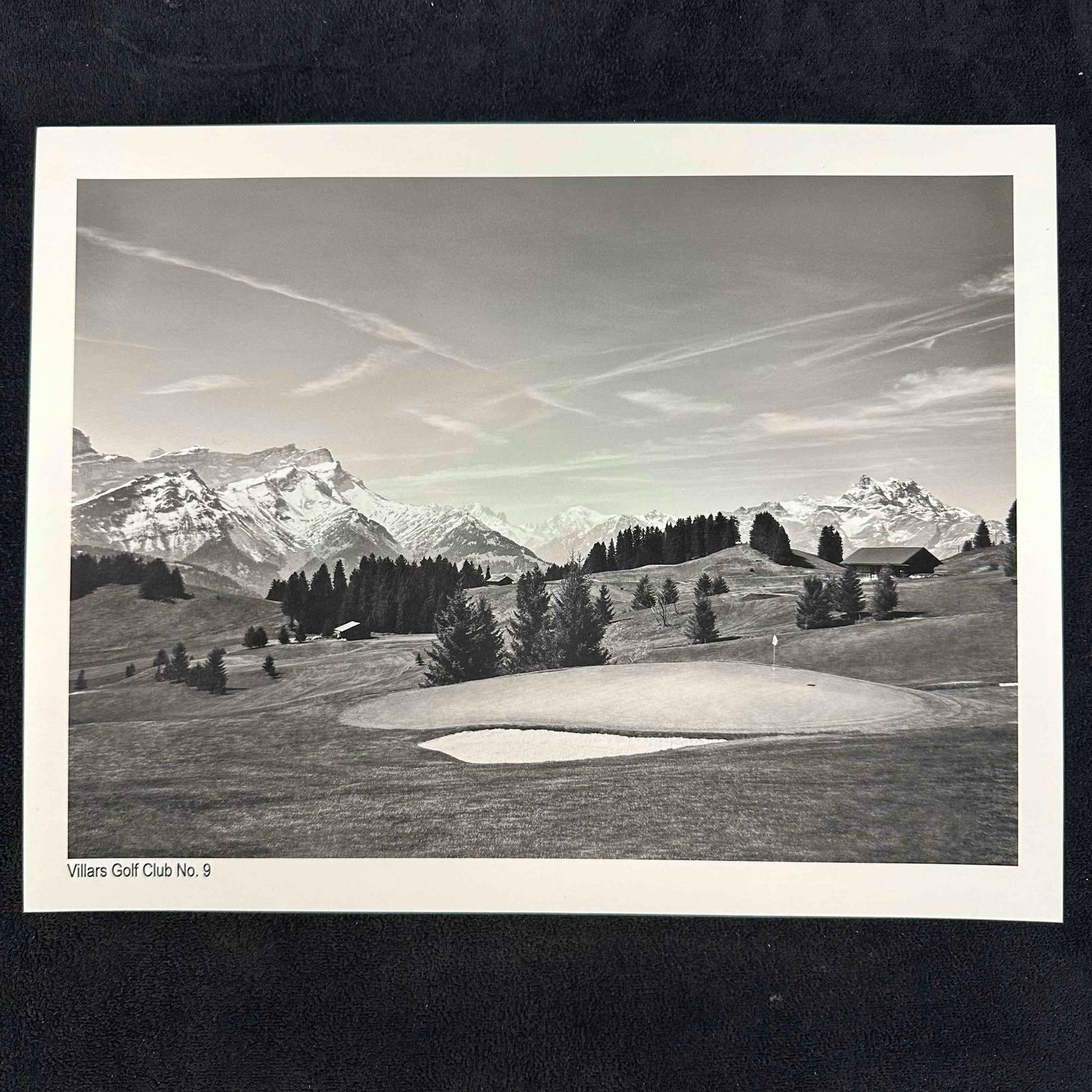 Villars Golf Club No. 9 Black and White Fine Art Photography Print: Black-and-white photograph of Villars Golf Club’s 9th hole, set against the breathtaking backdrop of the Swiss Alps. The image highlights the serene fairway, surrounding trees, and distant snow-capp