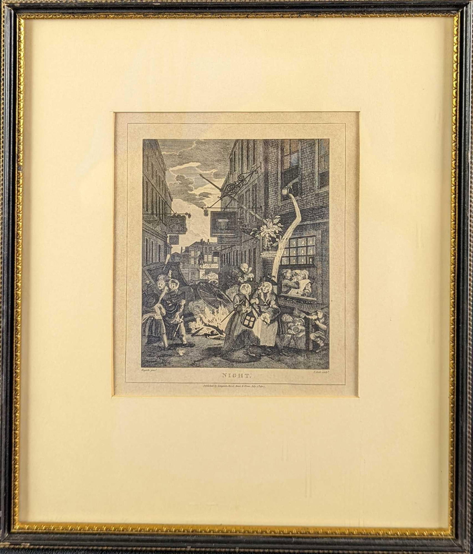 Framed Evening Engraving By T. Cook After W. Hogarth: The print shows the horrors of low life in town, where the statue of Charles I can be seen dimly over a sordid street full of bagnios and quacks. This engraving was published in 1807. The original was