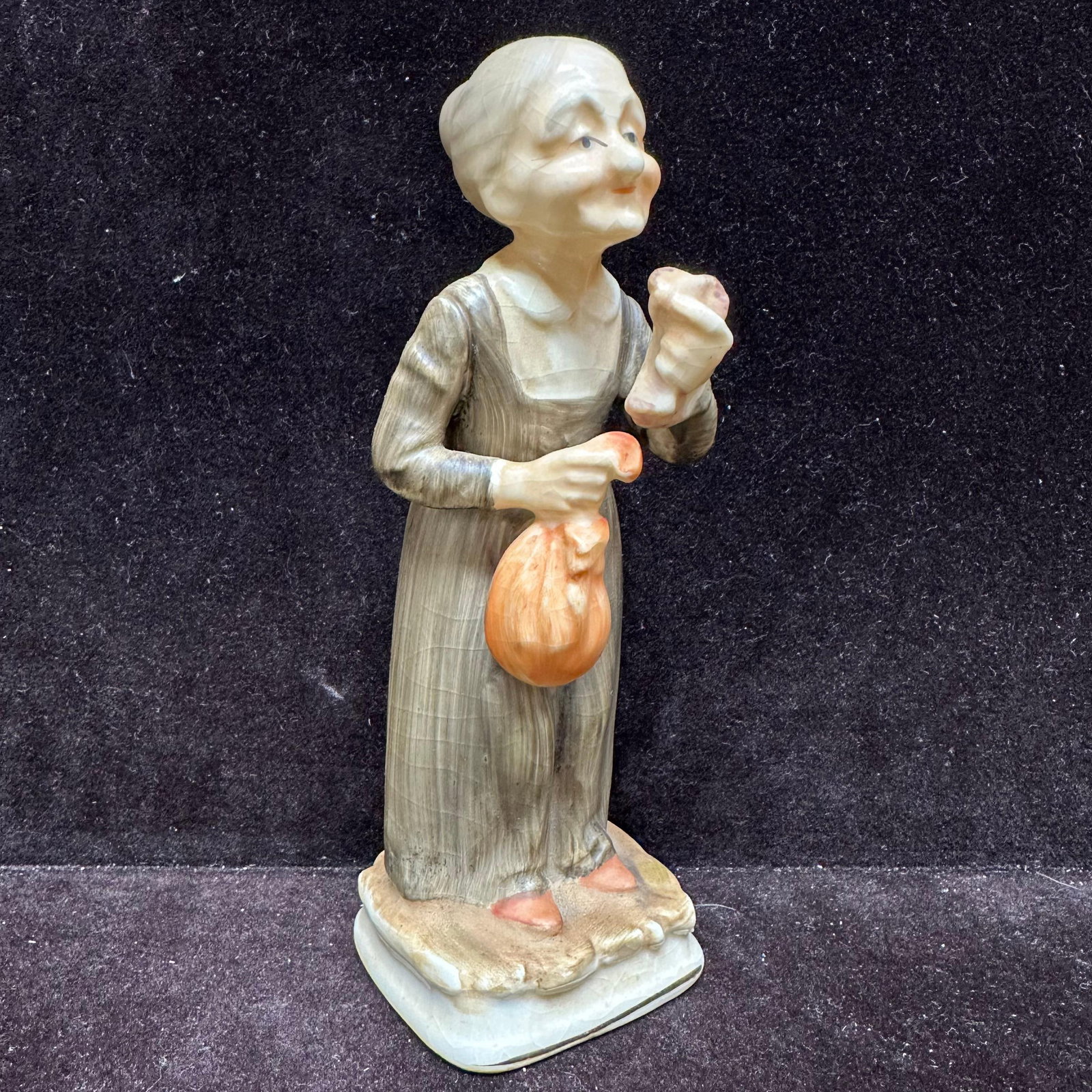 Vintage Ceramic Old Lady Figurine: Vintage Ceramic Old Lady Figurine. This lot contains: (1) Norleans Old Women Ceramic Figurine Made In Japan. This is approx 2 1/2" x2 1/4" x6 7/8". The figurine has some crazing. The to