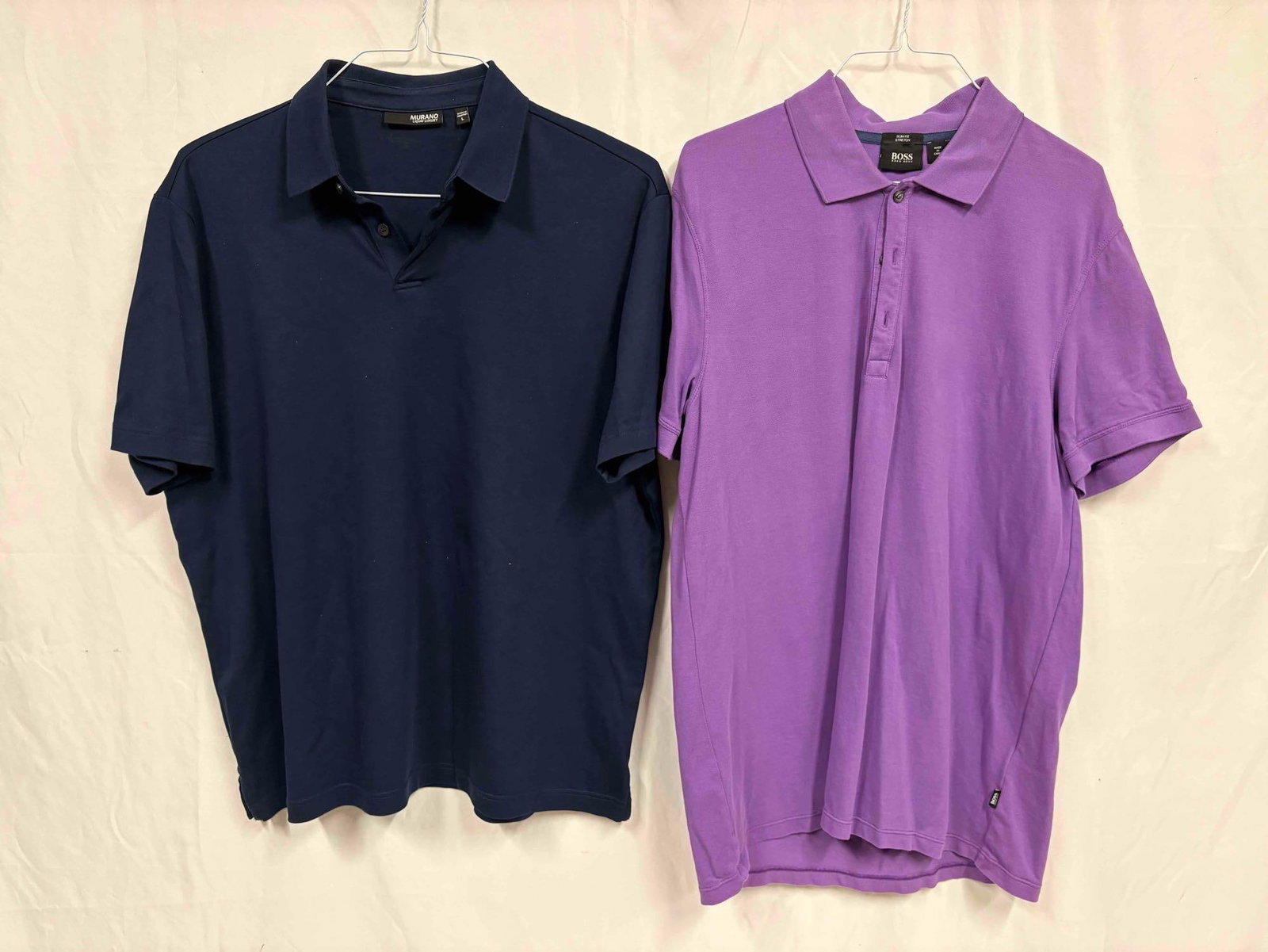2PC Hugo Boss and Murano Purple and Navy Blue Mens Polo Shirt Bundle: This lot contains a set of men's short sleeve dress shirts. Both the Hugo Boss and Murano shirts stand in like-new conditions without tags. Please refer to images for further context on the shirt&