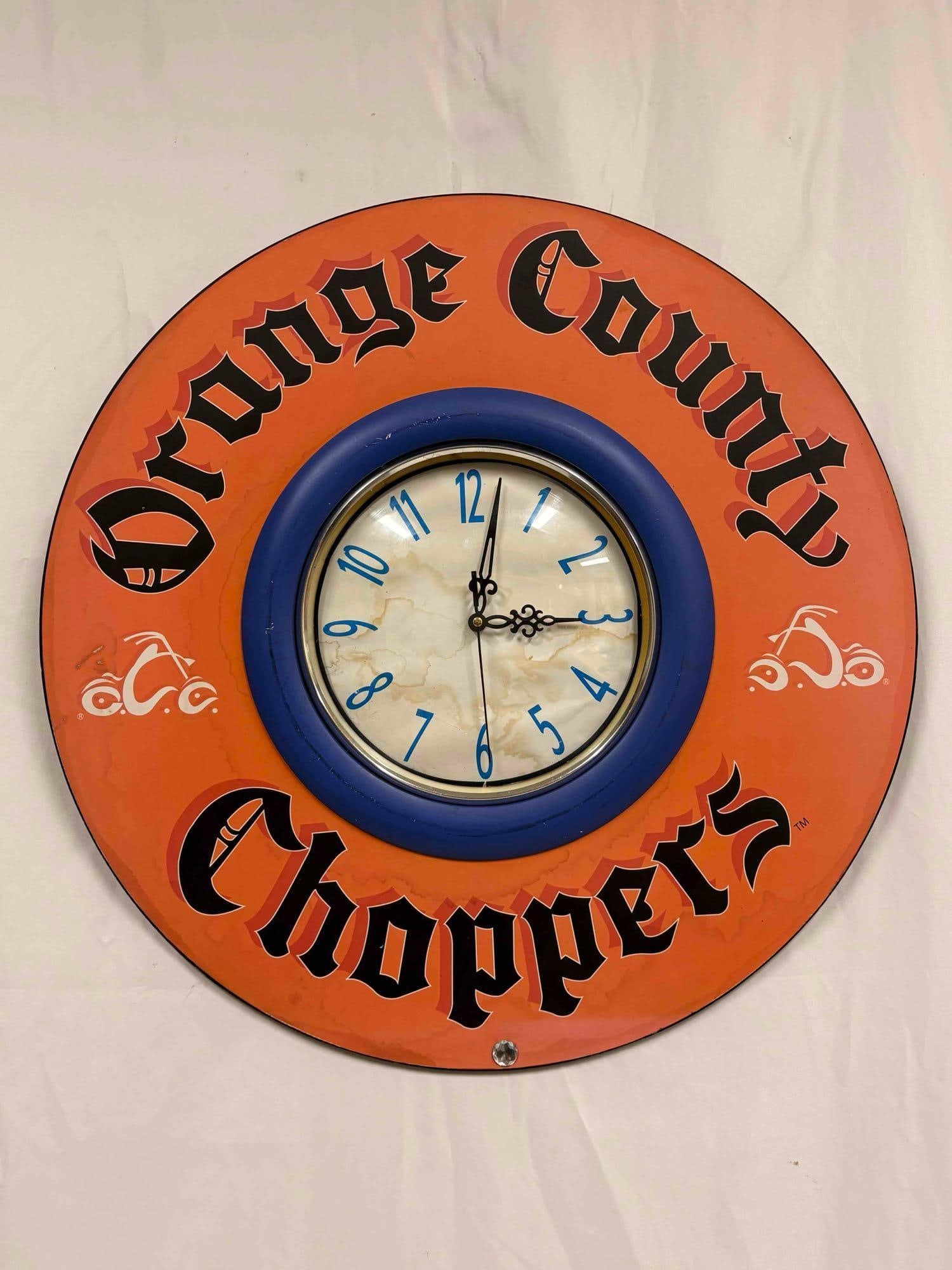 Orange County Choppers Wall Clock: This lot contains a bright orange, collectible Orange County Choppers (OCC) wall clock. OCC being well-known for motorcycle fabrication and its reality TV Show, American Chopper. Typically ranging fro