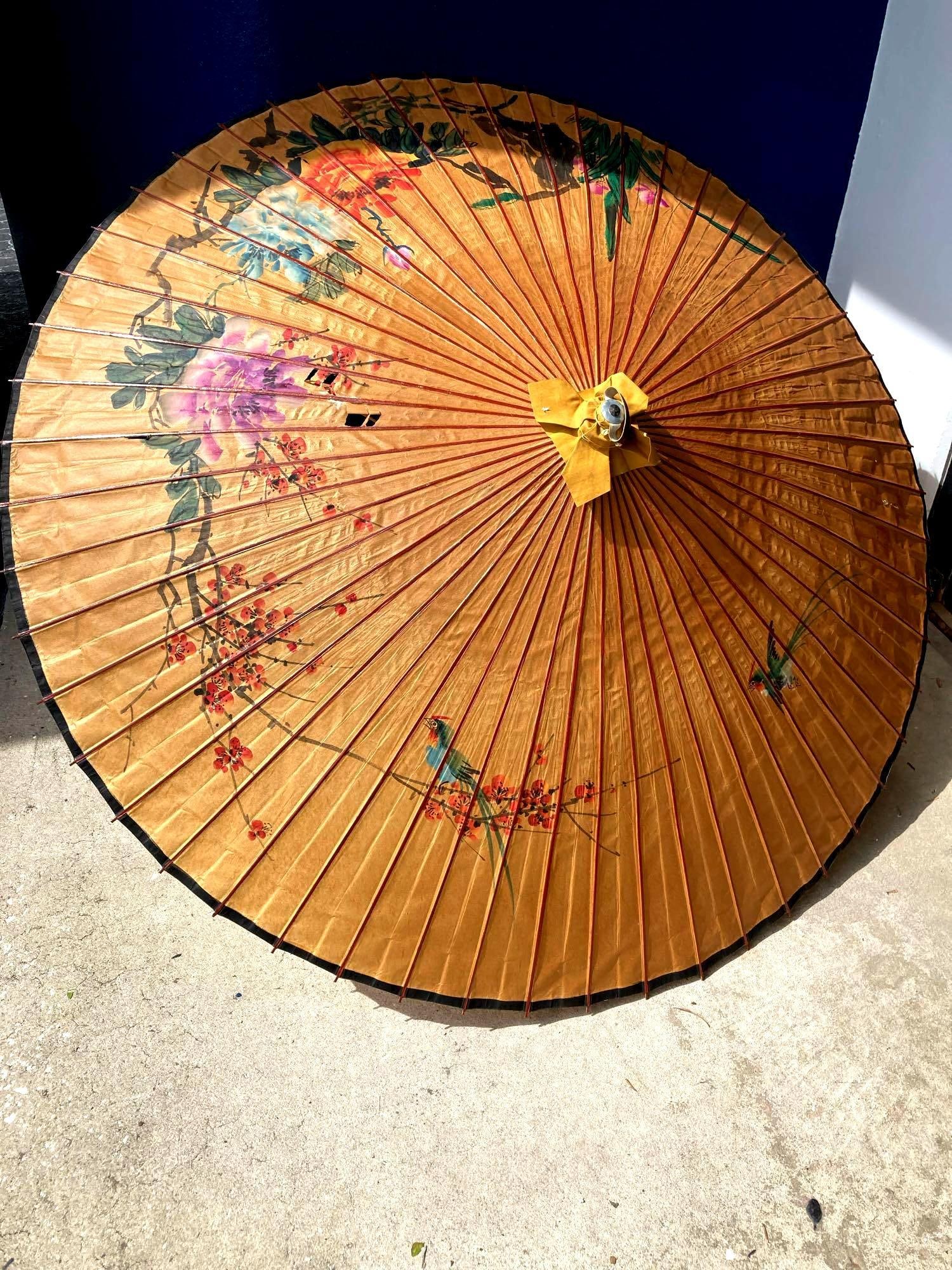 Large Japanese Parasol Umbrella: Up for auction is a recent estate find, a large Japanese parasol umbrella with flower and bird designs. This one is large and has a small vintage sticker that says, "Made in China." The design