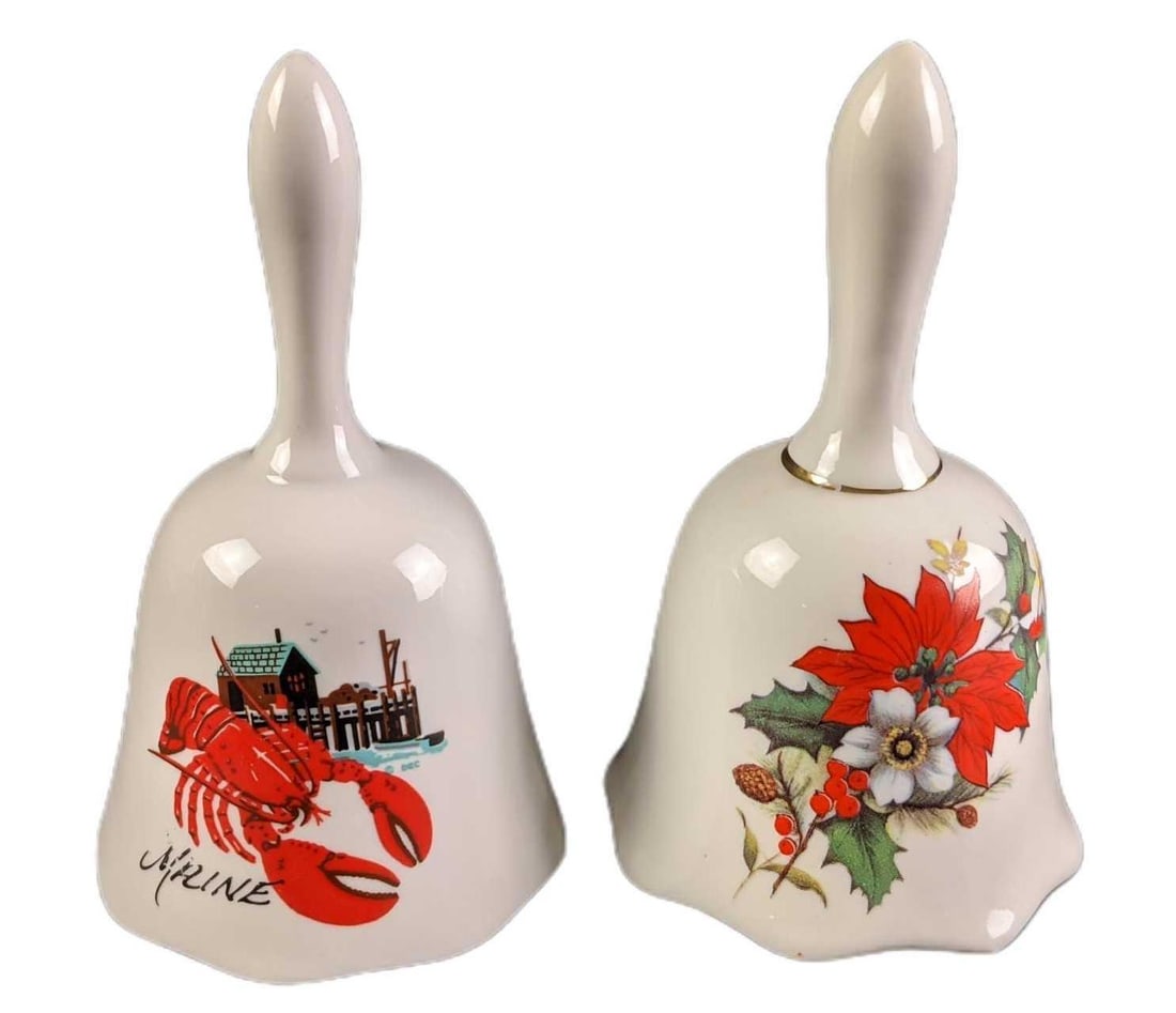 Vintage Maine Lobster And Floral Porcelain Bells: This lot includes: (1) Maine With Lobster Bell. This is approx 3" x 3" x 5". The M and A on the bell has some small scratches. (1) Floral Bell. This is approx 3" x 3" x 5". The