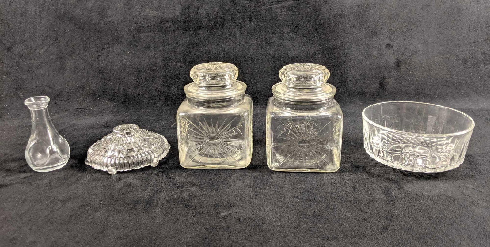 Random Selection Of Five Pieces Of Glassware: This is a collection of glassware: One candle-holder, a vial, an Arcoroc bowl, and two candy type jars. Measurements from left to right. 2' L 2'W 3 1.2'H 4' L 4'W