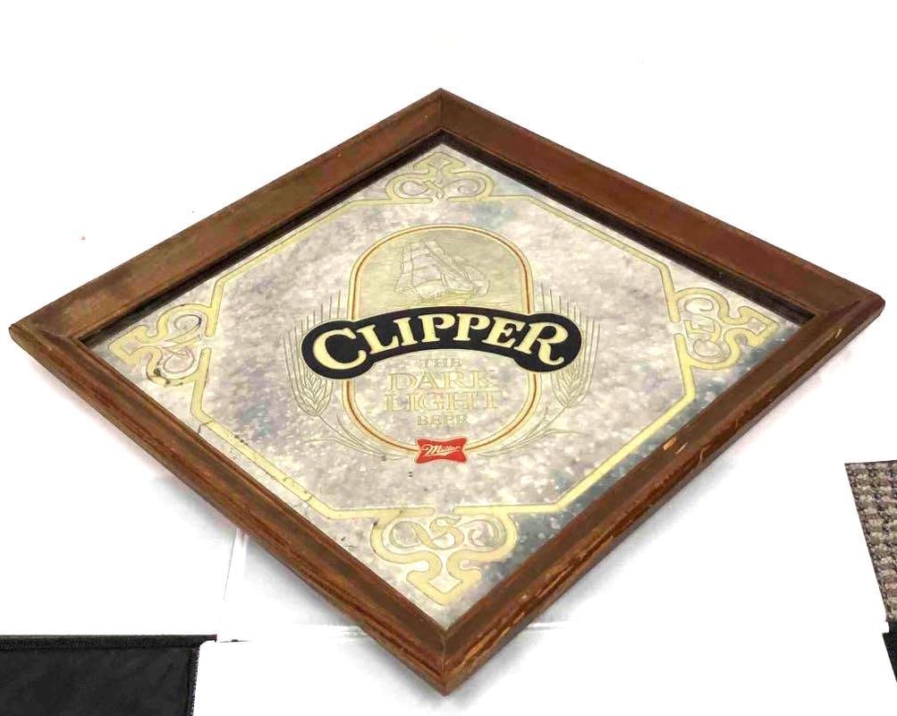Clipper The Dark Light Beer Mirror Miller: This lot contains a Clipper the dark light beer miller mirror. This is the perfect decor for any at home bar or man cave. It is approx 18" x 18" and 25 1/2 across diagonally and weighs about 4.5