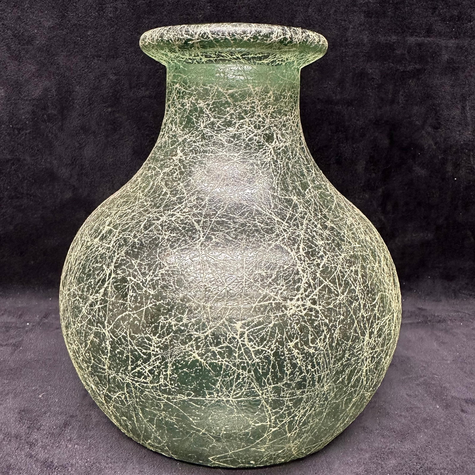 Green Crackle Webbed String Style Glass Vase Unmarked Bottle Type: Decorative green hue tinted glass vase featuring an allover crackle, webbed, string style finish. Rounded tear drop teardrop-shaped body with a wide flared rim. Appears to be molded glass. Surface wea