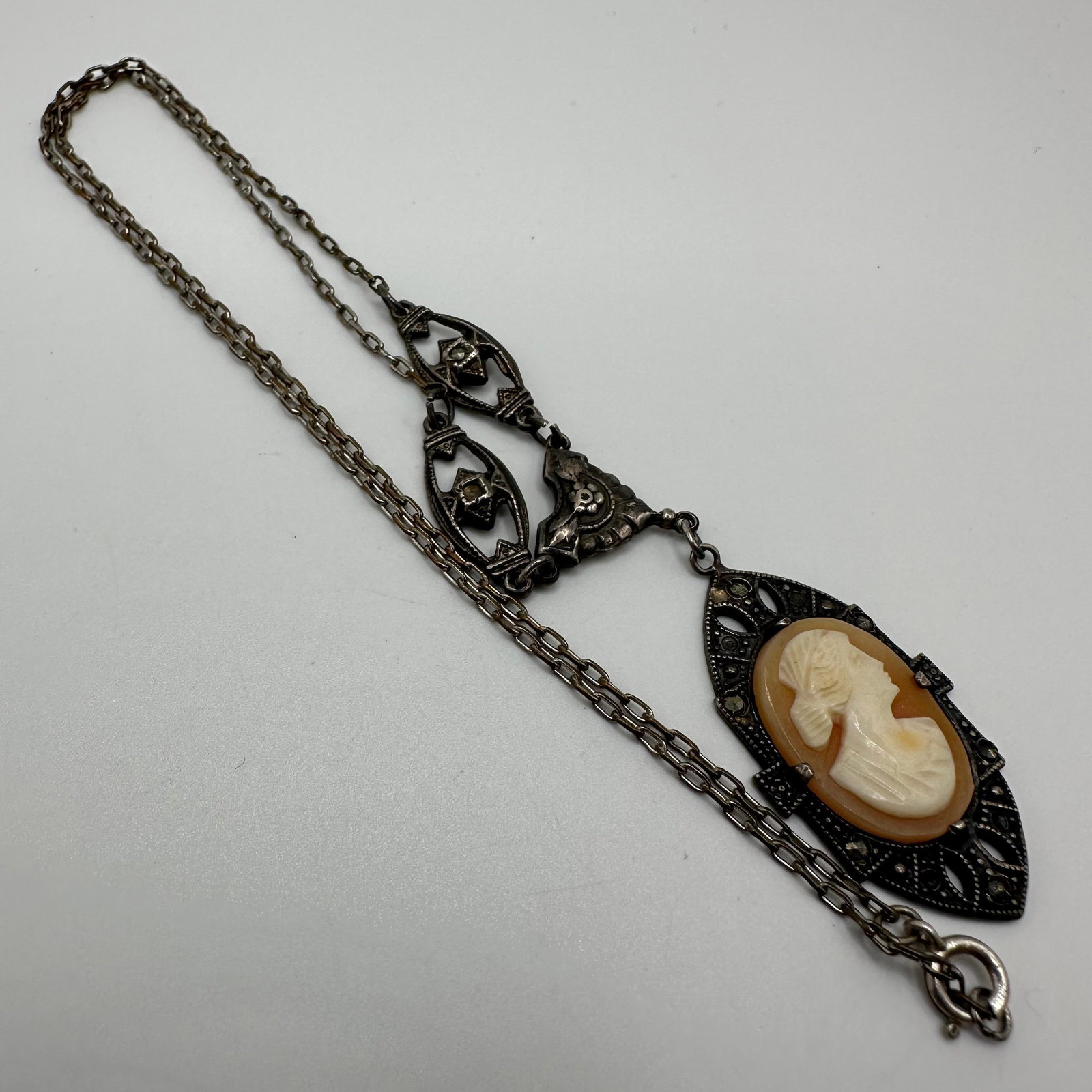 Carved Shell Cameo Marcasite Sterling Silver Antique Necklace: This item is in good pre-owned, previously used/displayed condition with noticeable light wear and surface scratches. Please reference all photos for full details. This piece of jewelry has been teste