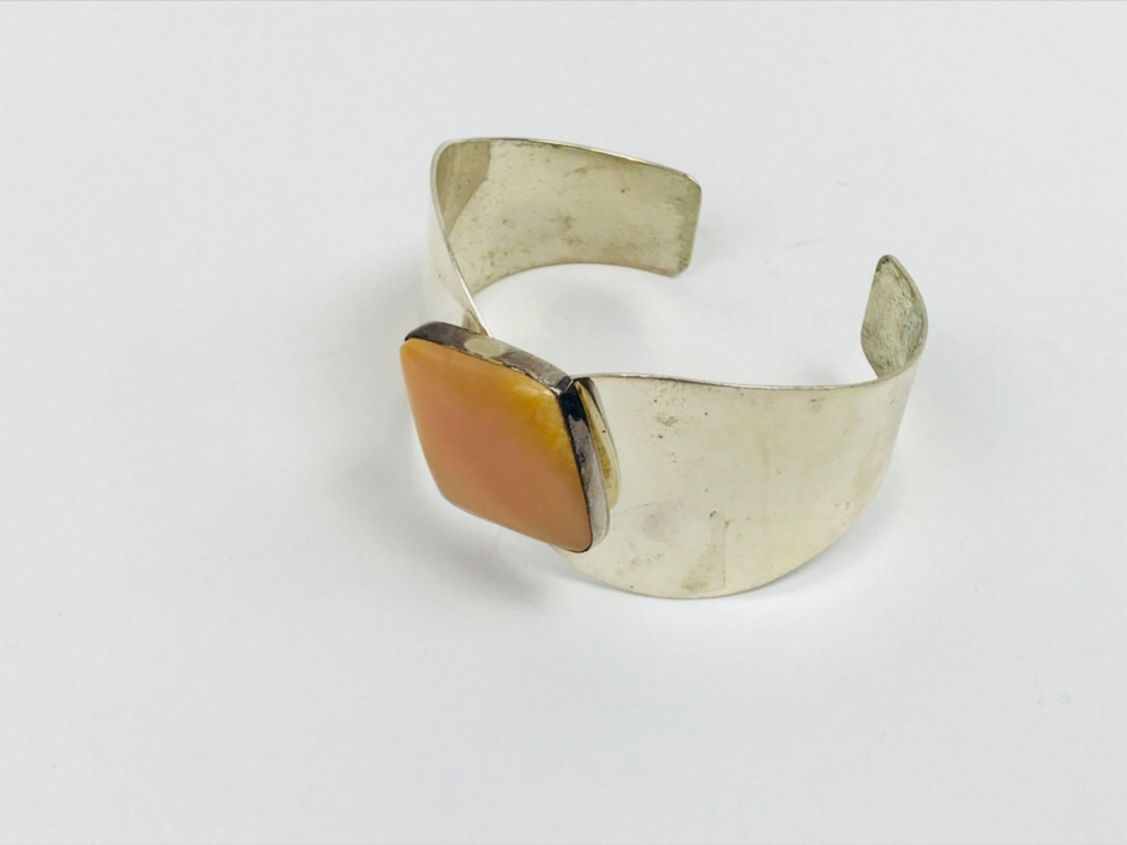 Desert Rose Trading Southwestern Sterling Silver Bracelet: Desert Rose Trading Southwestern Sterling Silver Bracelet; Features a lovely coral stone. Measures at approximately 2 1/4" D, marked DTR .925. Overall weight is 36.1 g.