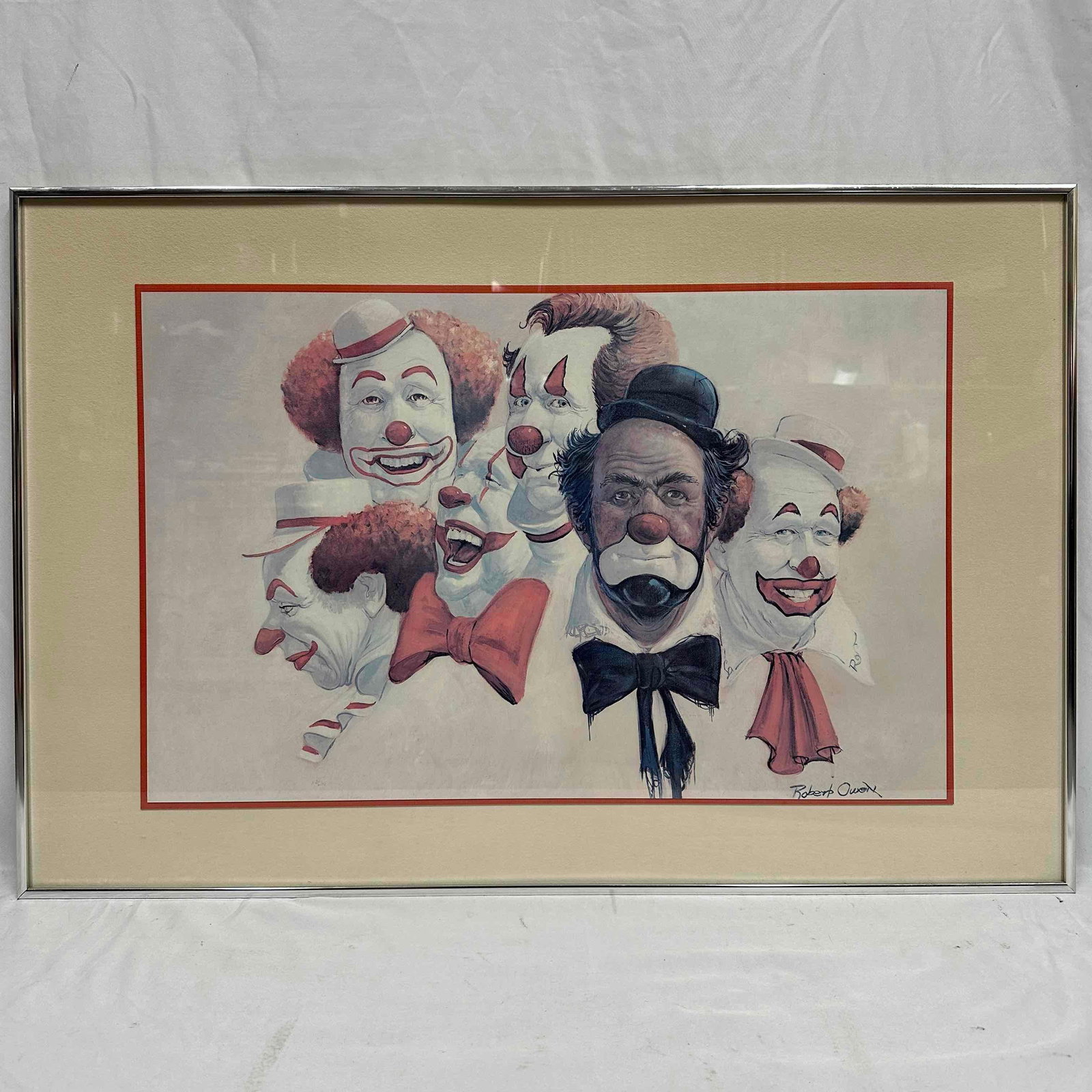 Robert Owen Clown Print The Burbank Six Clowns Large Framed Art: This print by Robert Owen, an artist known for his clown-themed works. Depicts a group of six clowns, with the central clown featuring black and white makeup, while the others have white faces. This i