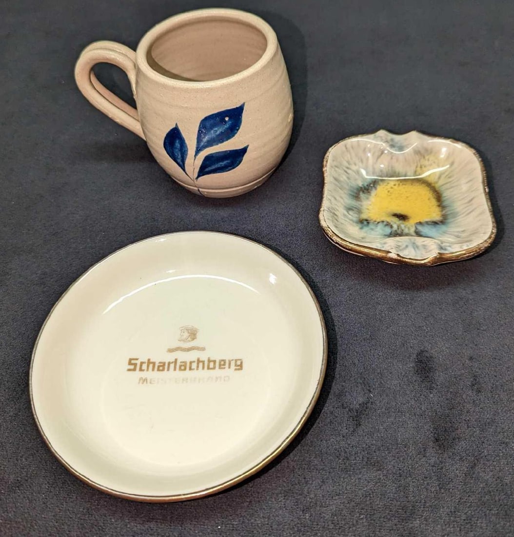 Vintage Porcelain Ashtrays And Pottery Mug: Vintage Porcelain Ashtrays And Pottery Mug. This lot contains: (1) Williamsburg Pottery Mug. This is approx 4 1/2" x 3" x 3 1/4" and it weighs 0.53lb. (1) German Ceramic Mini Ashtray. This