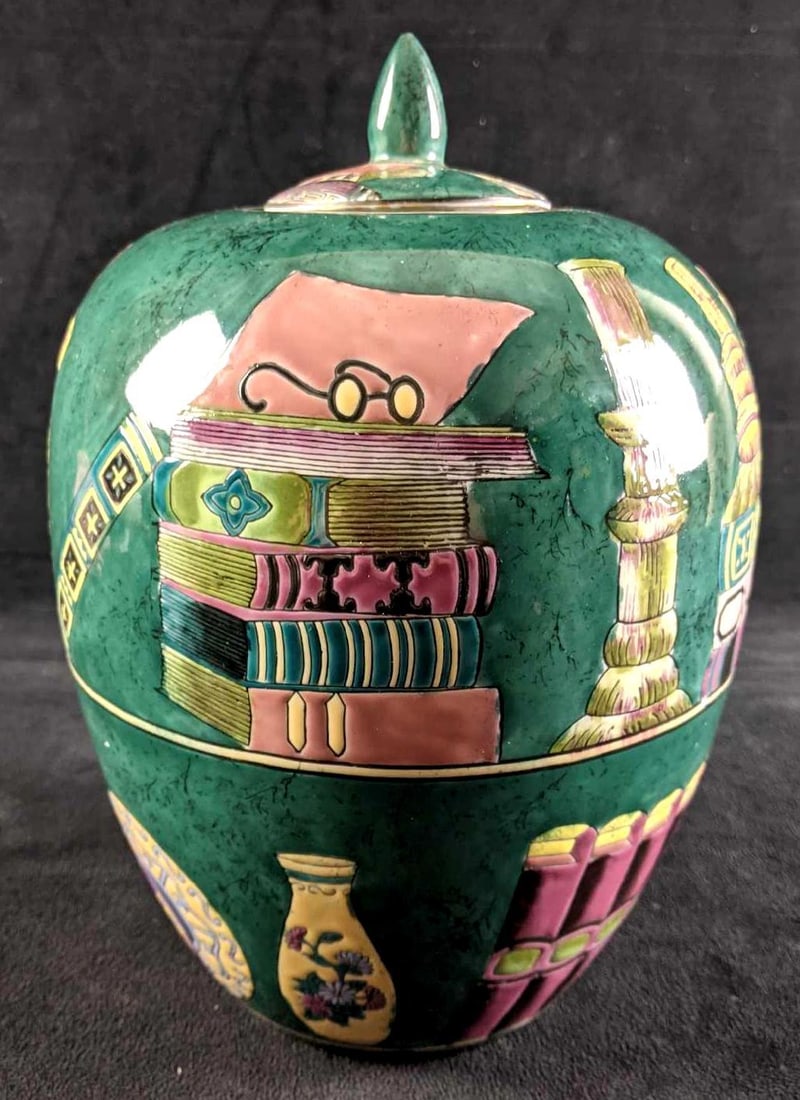 Large Green Lidded Vase: Large Green Lidded Vase This vase is in good condition with no known damage. The Vase shows a scene f what looks like a home library with books and even some decor. The vase is beautifully painted and
