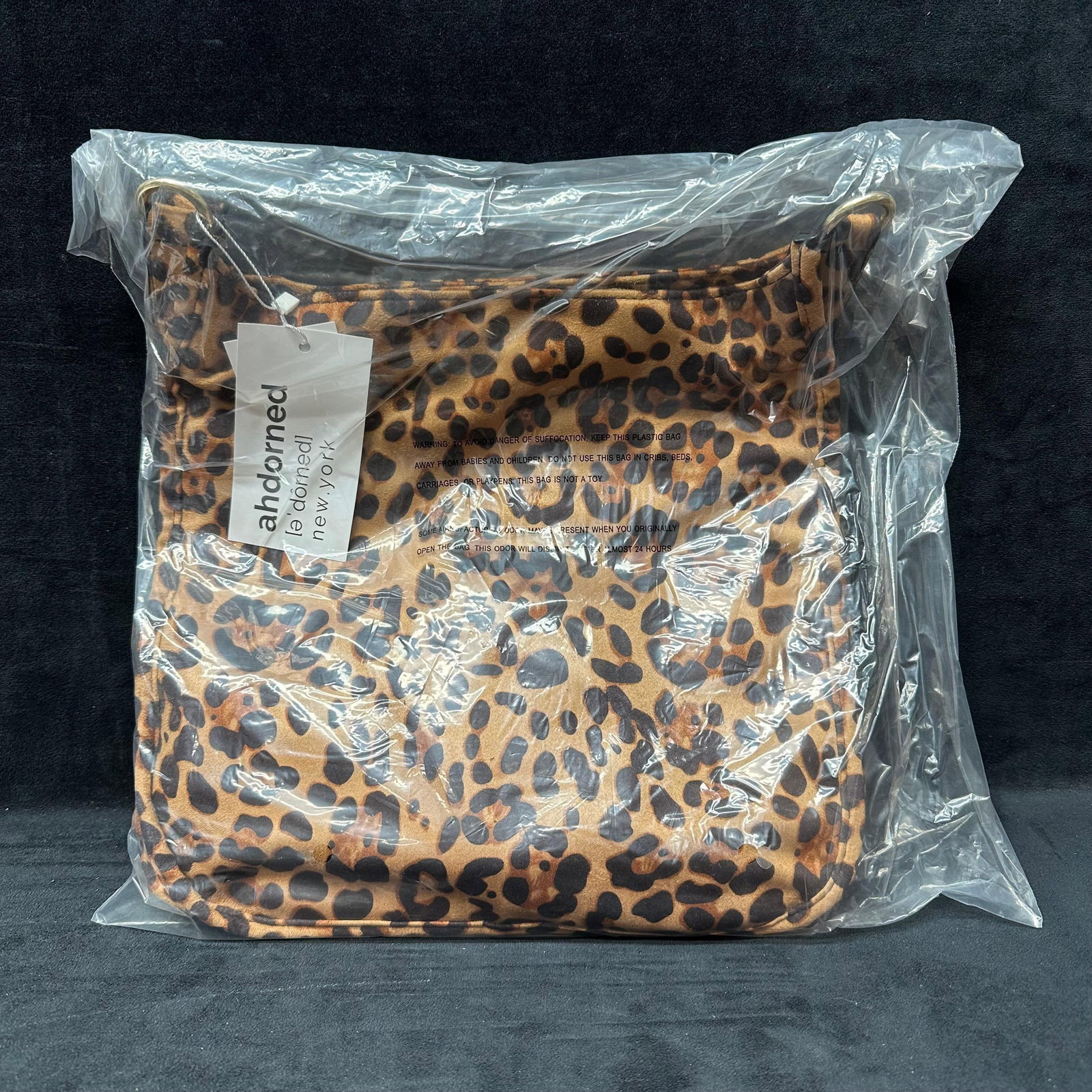 Ahdorned Leopard Print Shoulder Handbag With Strap: Ahdorned leopard print shoulder handbag with detachable strap. New with tags and still sealed in original plastic packaging. Includes strap in separate packaging. No visible use. This item is in new,