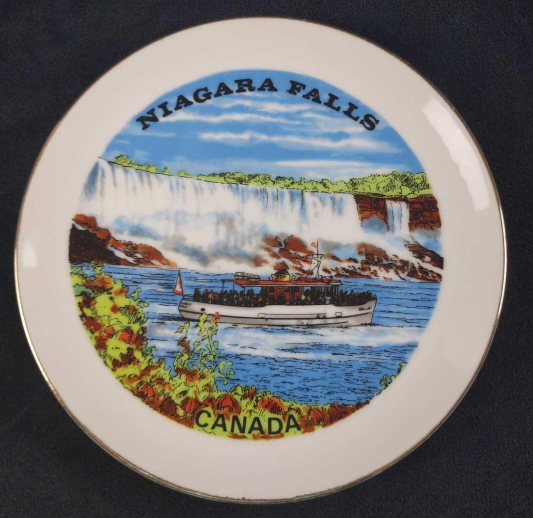 Vintage Porcelain Niagara Falls Canada Plate: Vintage Niagara Falls Canada Porcelain Souvenir Plate. Shows a tour boat sailing past some of the falls. Graphics were pressed on, while the colors were done by hand, Made In Japan. The plate