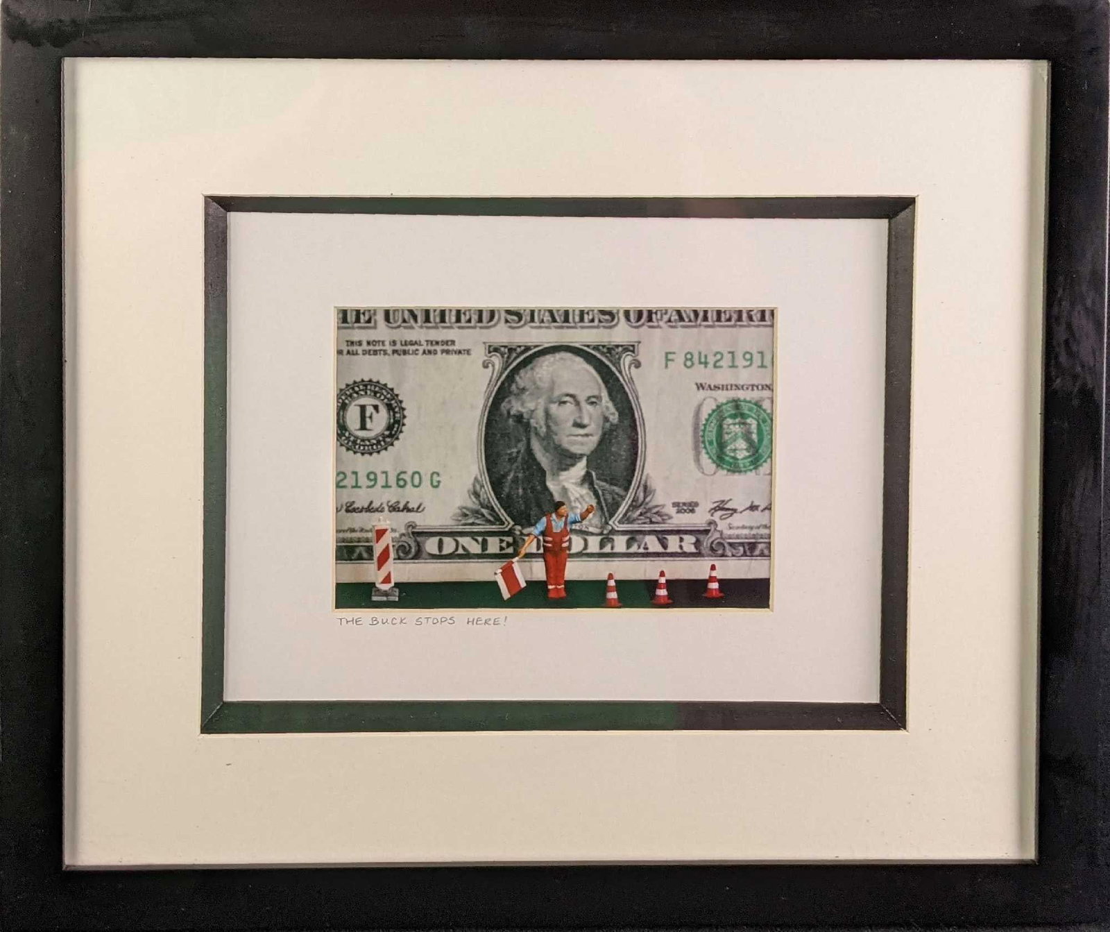 Framed "The Buck Stops Here" Novelty Photo: The framed photo called "The Buck Stops Here" shows an American dollar bill being stopped by a construction-type worker waving a flag. This was not signed by the artist. Framed photo is approx 16" x