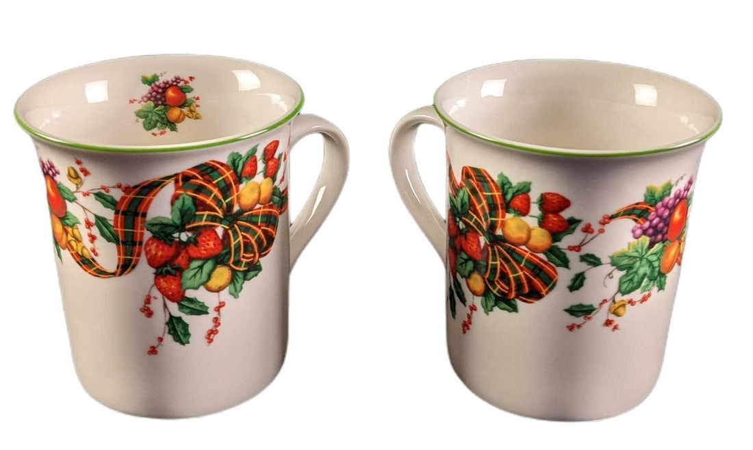 Two William James Stonewear Fruit & Grim Trim Mugs: This lot includes two stone-wear mugs from William James. These mugs have a lovely ribbon, fruit, and a nice green trim on the top. These would work well with the Christmas holiday or any other day