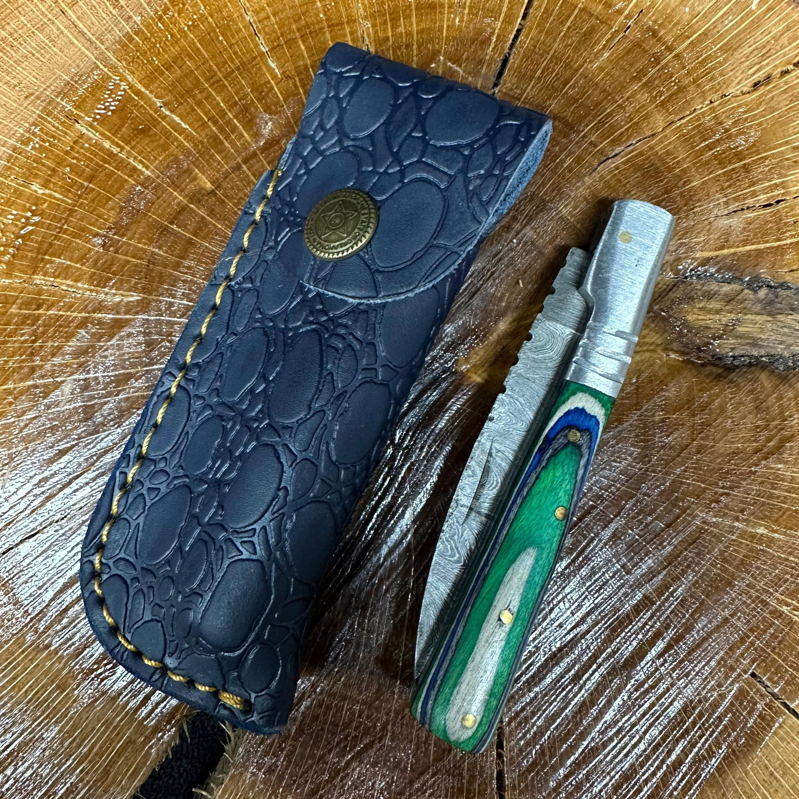 MHS Cutlery Steel Folded Blade Pocket Knife Blue Green Handle Q93: Folding blade pocket knife by MHS Cutlery featuring a steel blade and decorative spine work. The decorative handle has a contoured, blue/green wood/resin-style grip with metal mosaic pin accents. Incl