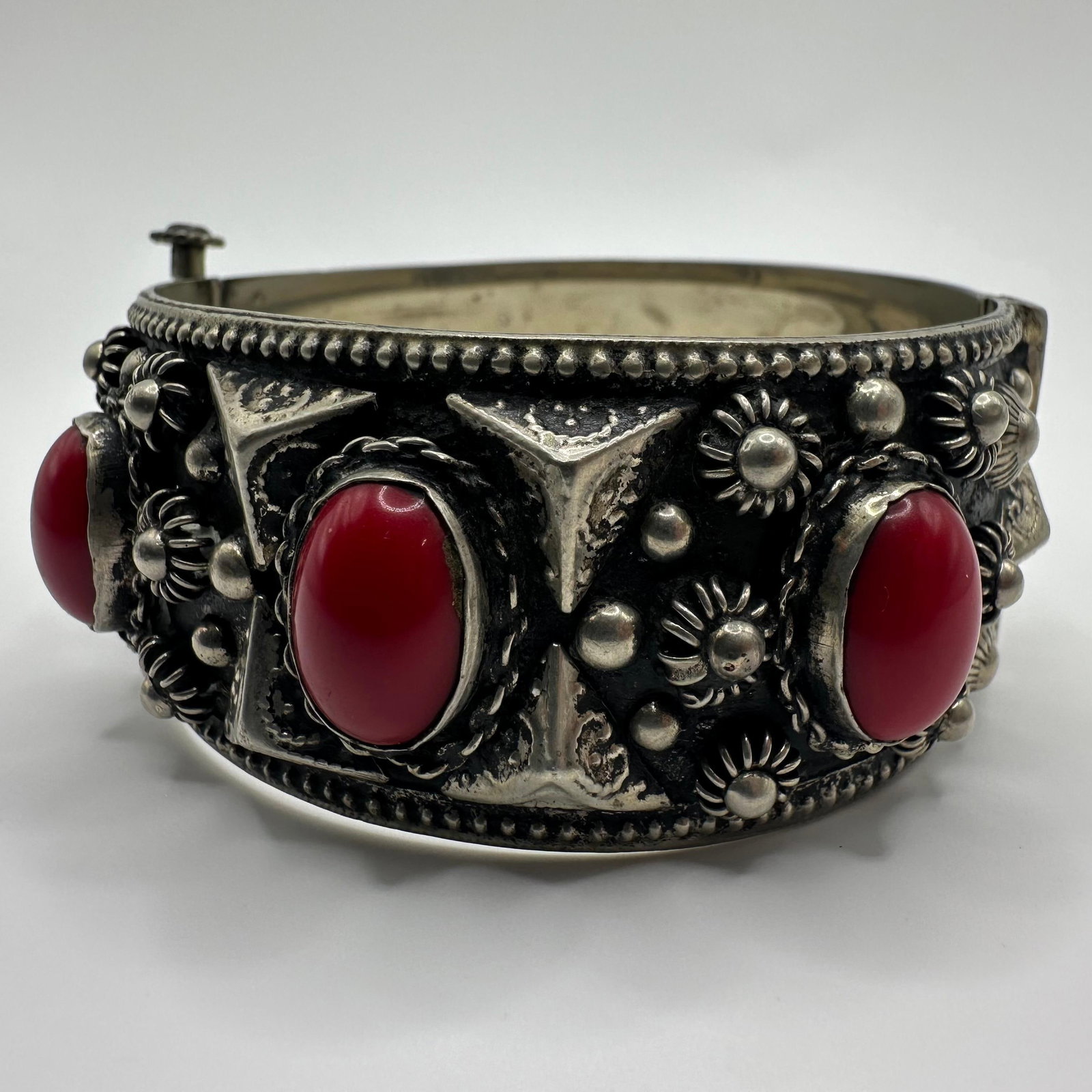 Alp Alpaca Nickel Base Metal Hinged Cuff Bracelet: Marked Alp with a red cabochon and floral detail; Marked ALP with faux stone cabochon accents. Visible surface wear and tarnishing are consistent with age. These items are in pre-owned, previously dis