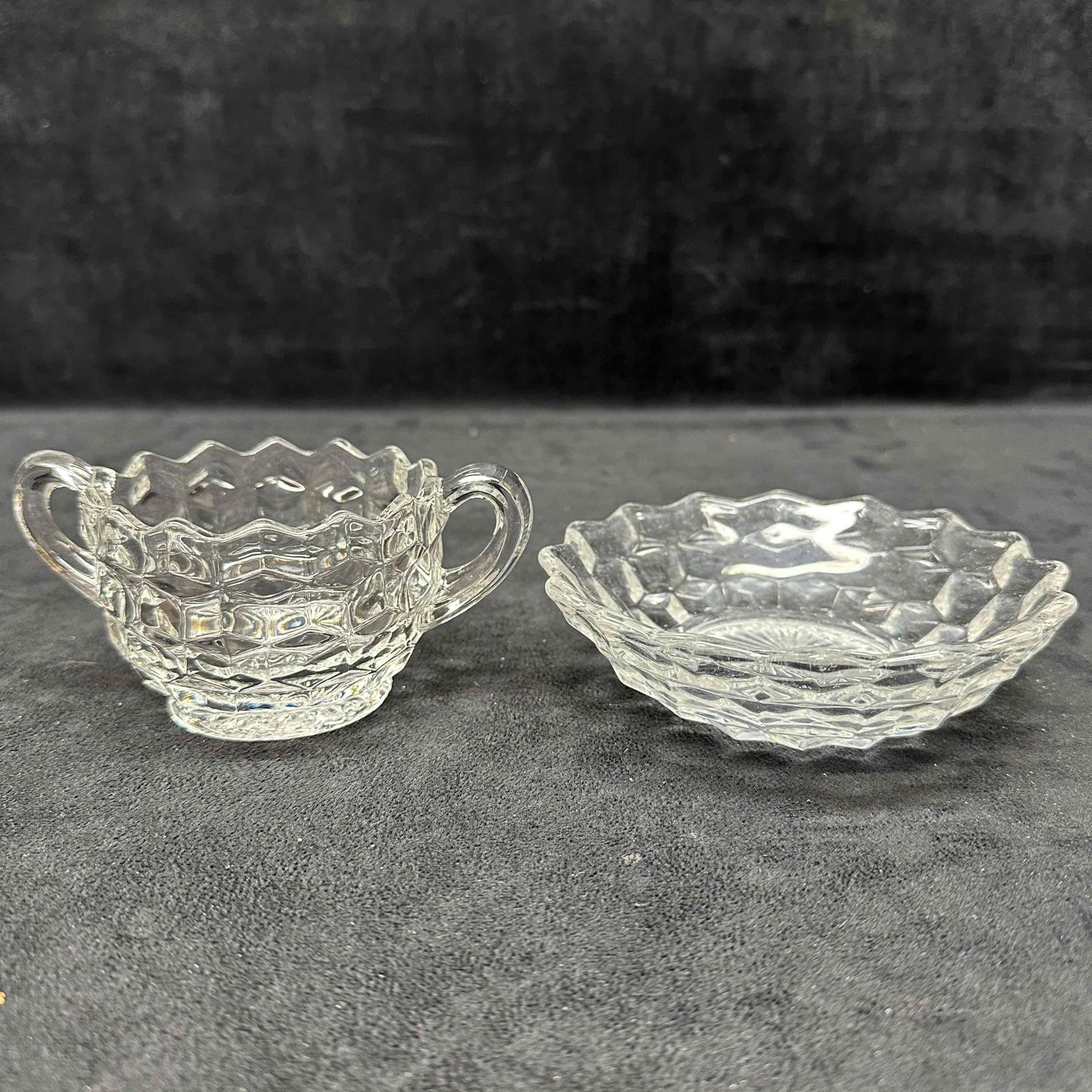 Fostoria American Clear Glass Set Bowl Dish and Double Handle Cup Cubist Pattern: The Fostoria American Clear glass pieces are from the American pattern. This pattern, known for its block geometric design, and was produced until 1988. A few of the glassware pieces show minor scratc