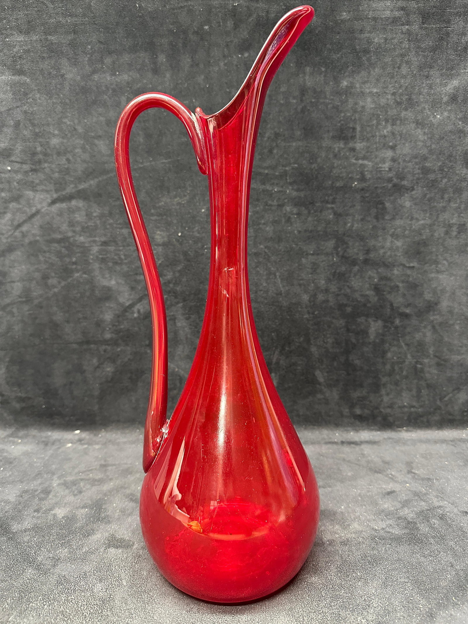 Mid Century Modern Ruby Red Art Glass Ewer Stylized Pitcher Vase: This item is pre-owned with noticeable age wear and slight imperfections. Please reference all photos for full condition details. Approximate weight: 2.1 lbs. Approximate size: 16 3/4" x 6".