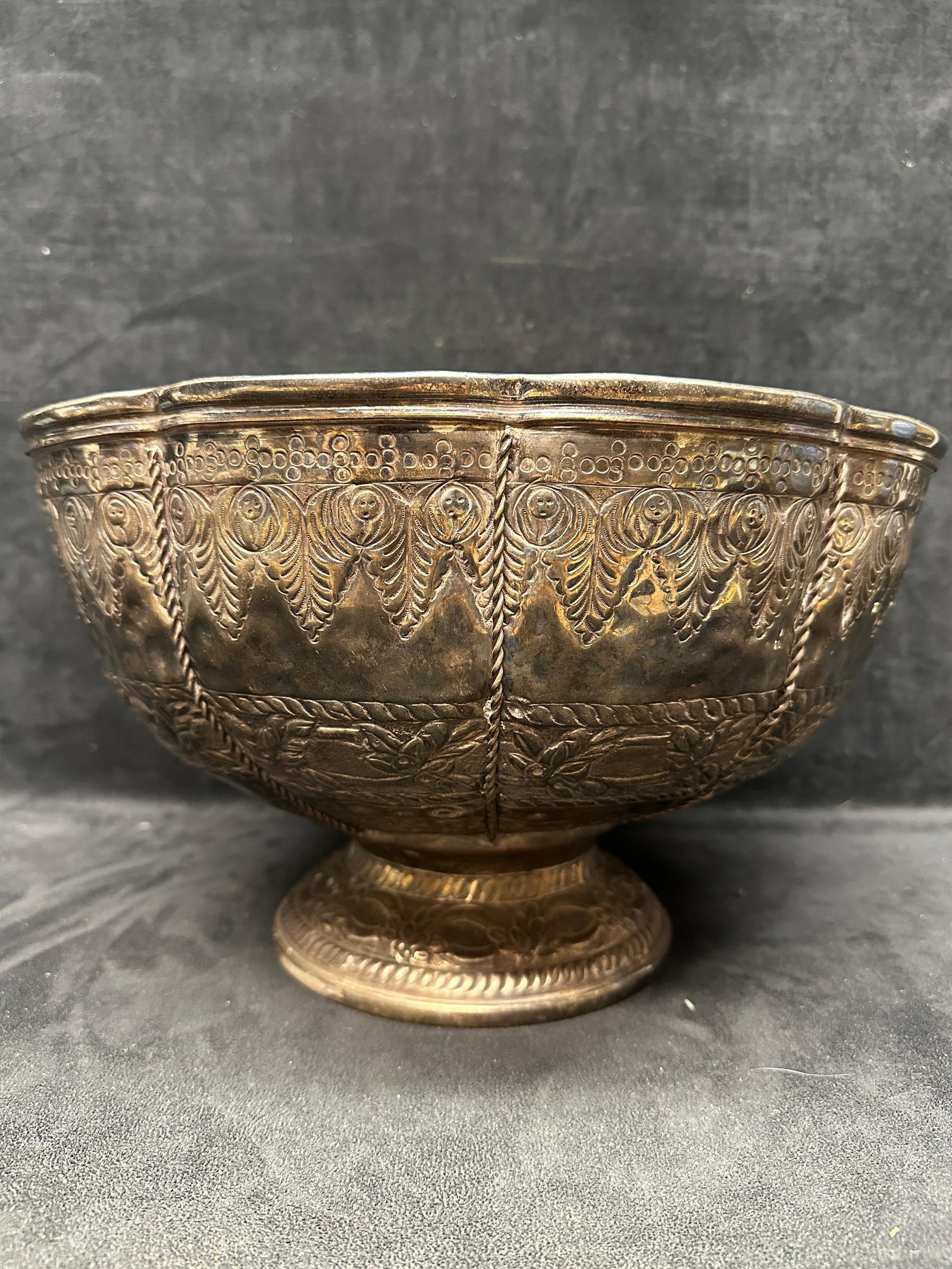 Intricate Repousse Etched Style Silver Plate Pedestal Bowl: Decorative pedestal bowl with scalloped rim and extensive repousse floral and geometric decoration design throughout. Features include hammered detailing, ornate bands, and a footed base in a Middle E