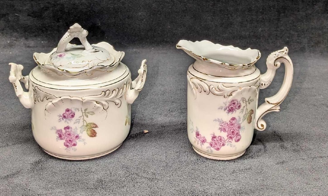 Vintage German Porcelain Creamer And Sugar Bowl: Vintage German Porcelain Creamer And Sugar Bowl. By Rosenthal & Co. The creamer is approx 4 1/4" x 3" x 4". This has some small markings inside. The sugar bowl with lid is approx 5" x 4" x 5". Th
