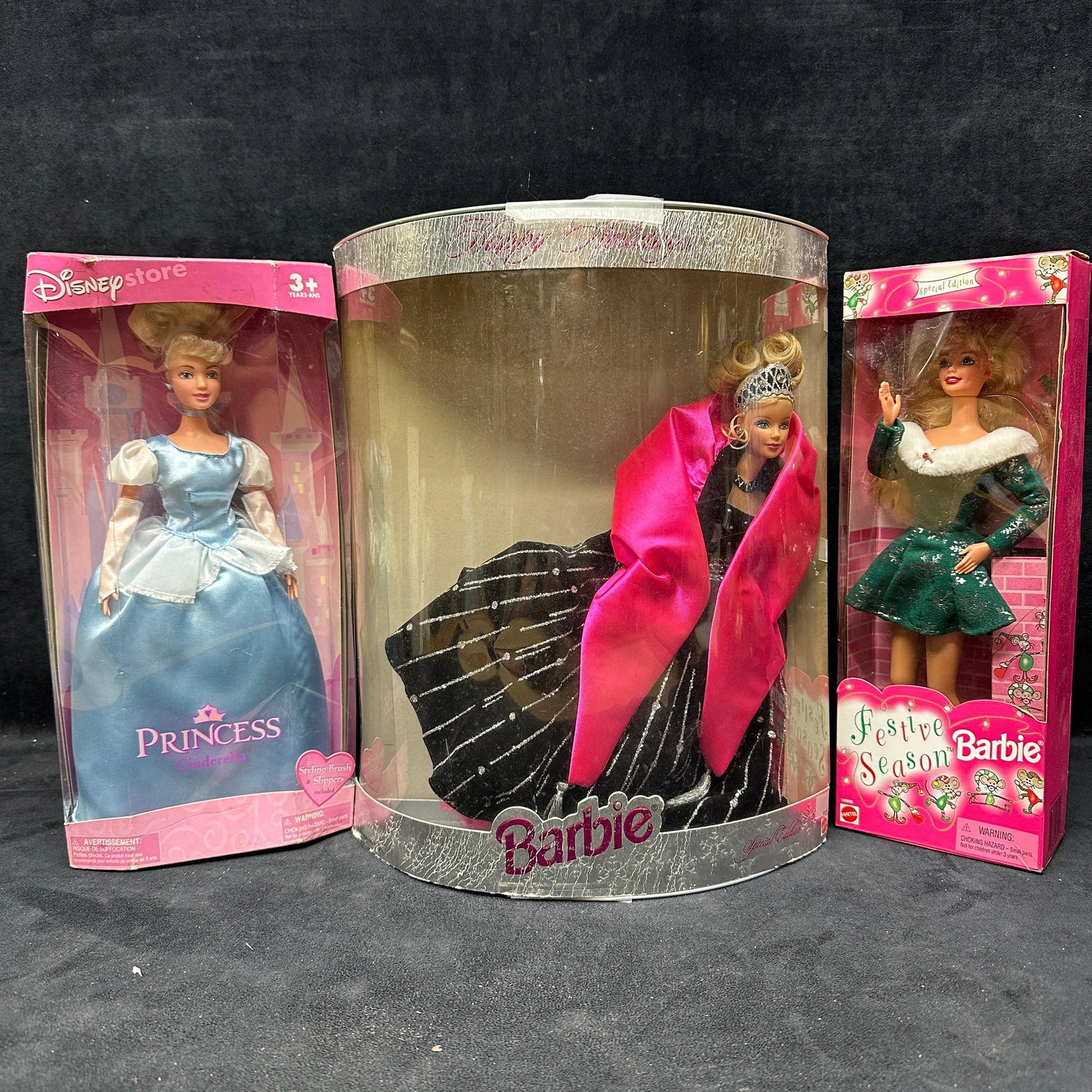 Barbie and Disney Princess Doll Lot Happy Holidays Barbie Festive Season Cinderella: A lot of three boxed dolls, including Happy Holidays Barbie, Festive Season Barbie, and Disney Store Princess Cinderella. All include the original box with original packaging opened. Boxes show storag