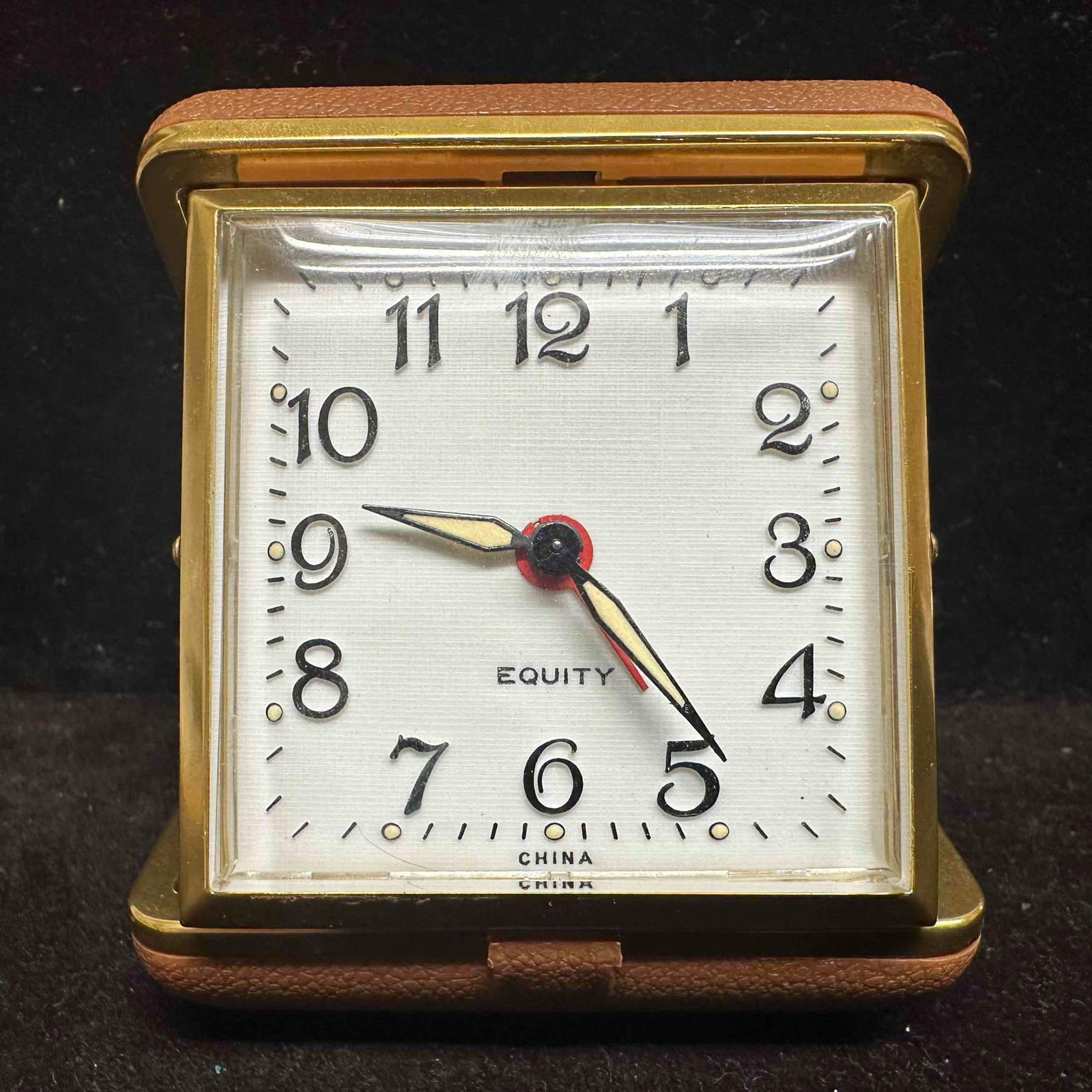 Equity Travel Alarm Clock Wind Up in Folding Case: This item is in good pre-owned previously displayed condition, with light wear, and some surface scratches. Please reference all photos for full details. Case: 2 3/4" x 2 3/4" x 1 1/4". We