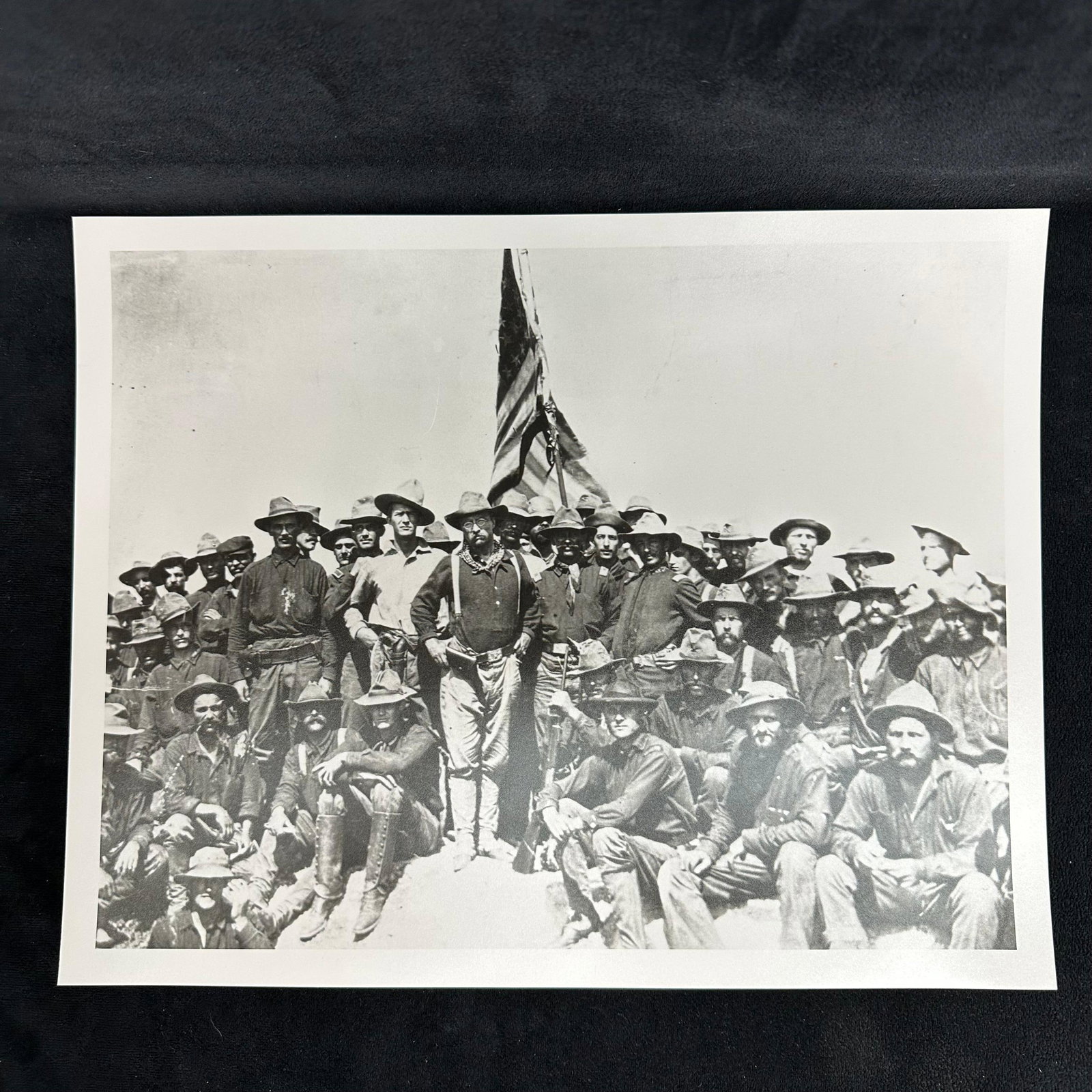 Theodore Roosevelt and Rough Riders Group Portrait Spanish-American War Era Analog Photo Print: Historic black-and-white analog photographic print depicting Theodore Roosevelt standing proudly among the Rough Riders during the Spanish-American War. Roosevelt, in his iconic campaign attire, is se