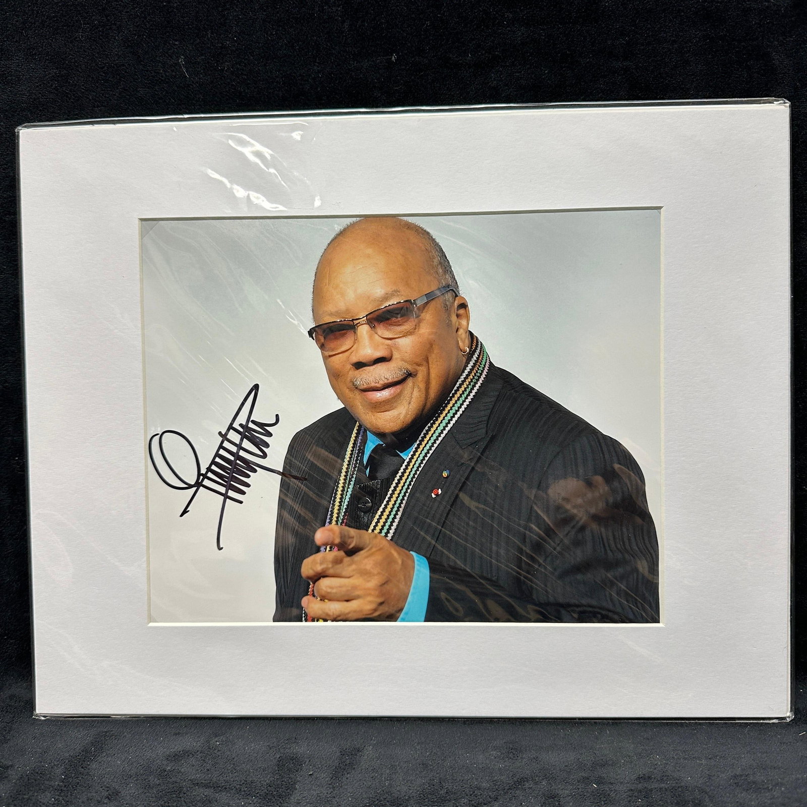 Quincy Jones Signed Color Photograph With COA: Color 10 x 8 photograph of Quincy Jones signed in black marker and matted for display. Signature appears boldly across the image. Presented under a protective sleeve with matting. Includes Todd Muelle