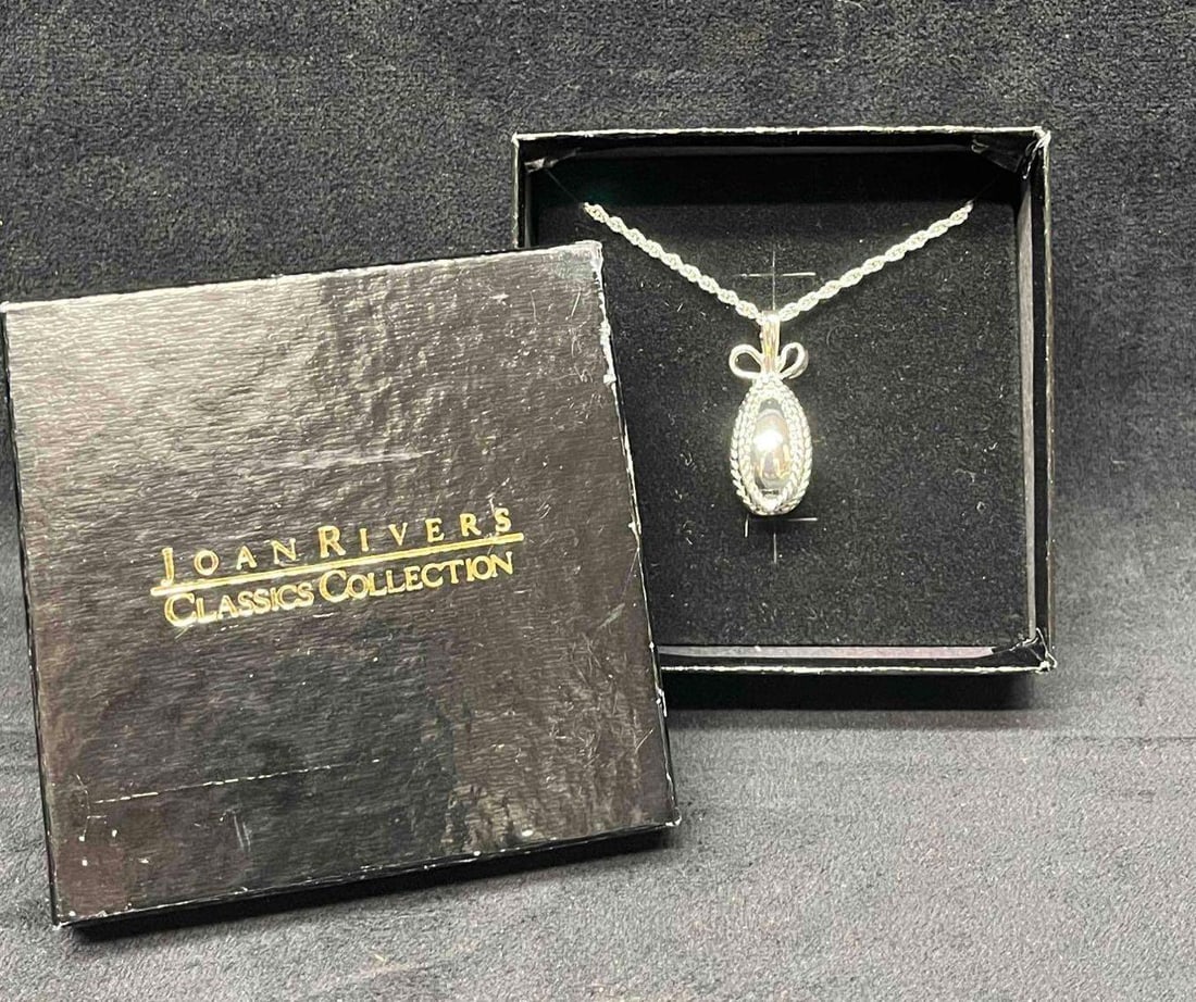 Joan Rivers Classic Collection Silver Tone Royal Faberge Egg Pendant Necklace In Original Box: This lot contains a Joan Rivers Classic Collection Silver Tone Royal Faberge Egg Pendant Necklace In Original Box. The original box is approx 3 3/4" x 3 3/4" x 1 1/2". The chain is 14 3/4" long.&