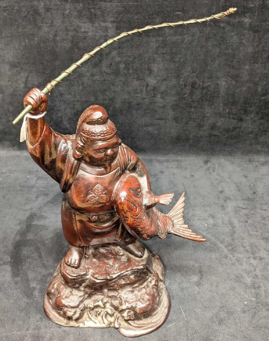 Vintage Japanese Ebisu God Of Fortune Sculpture: Vintage Japanese Ebisu God Of Fortune Sculpture. It appears to have a metal base and a heavy, stone resin figure of the god. The maker and date of creation is unknown. This is approx 8 1/2" x 6" x 16"