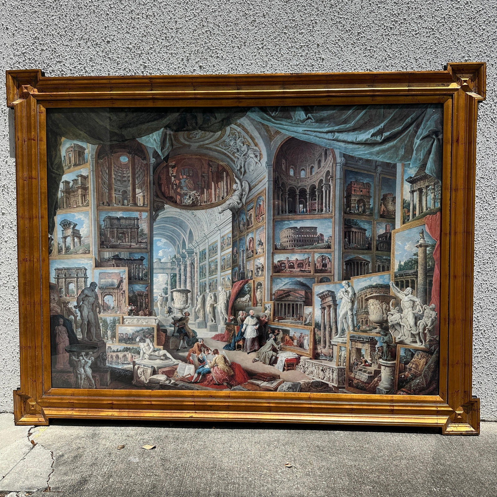 Large Italian Architectural Capriccio Style Framed Art Print R235: Large framed decorative print depicting an elaborate architectural gallery interior filled with Roman ruins, sculptures, arches, and classical scenes in the Grand Tour style. Presented under glass in 