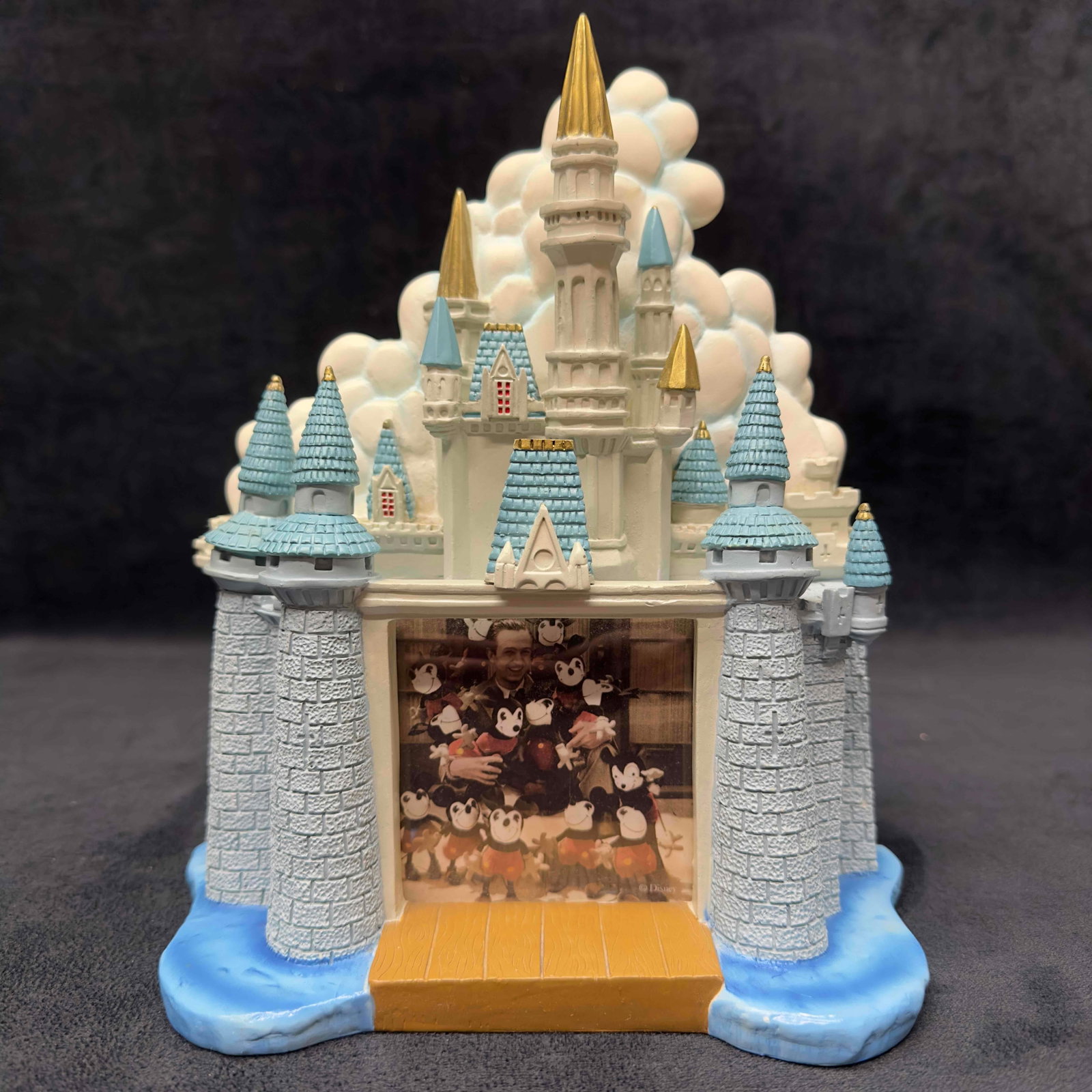 Walt Disney World Cinderella Castle 3D Ceramic Photo Frame: Walt Disney World Cinderella Castle 3D Ceramic Photo Frame. One castle turret is slightly chipped on the tip. Photo size 3 x 3”. Light dust due to storage. This item is in good pre-owned,