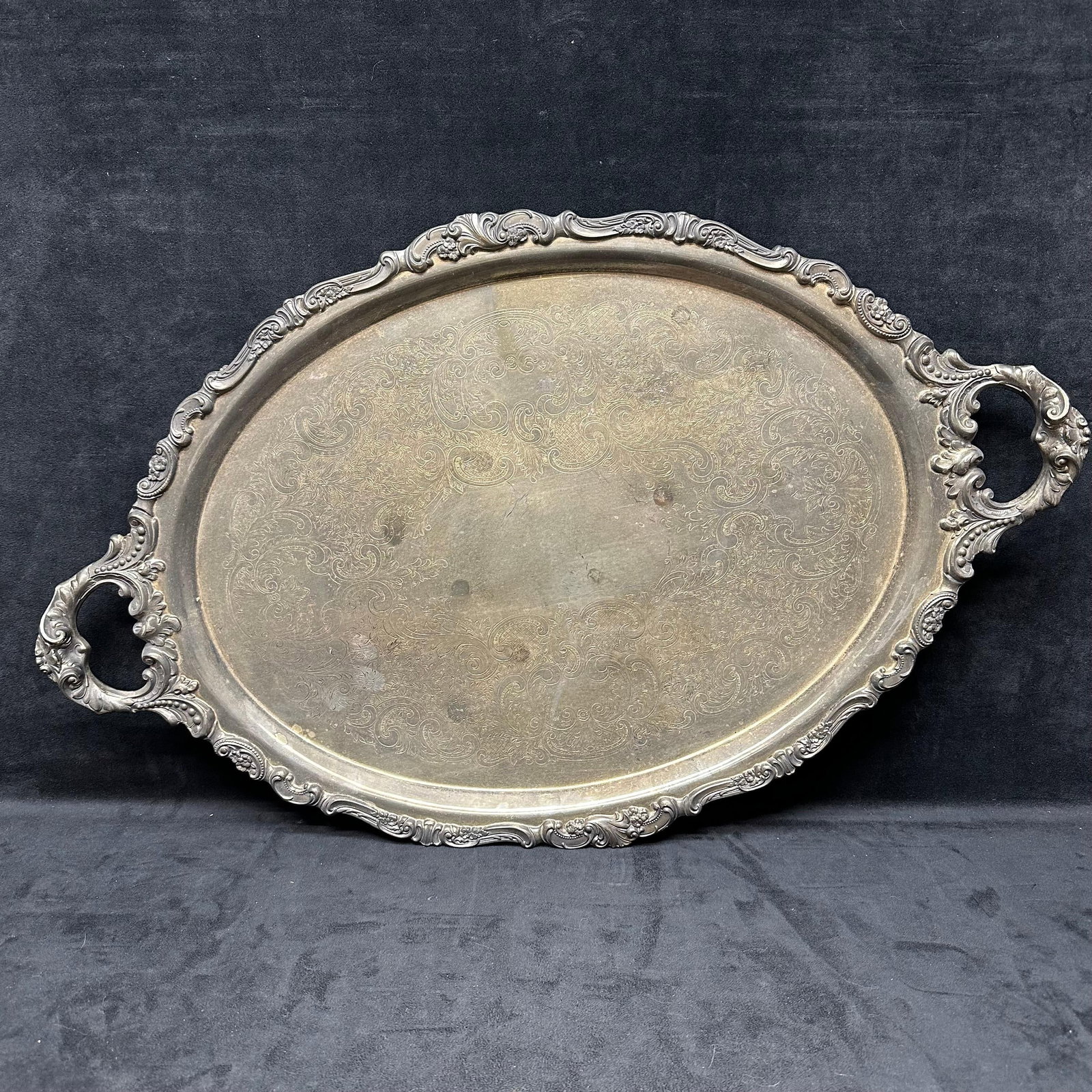 Vintage Wallace Silver Plate Oval Serving Tray Baroque by Wallace #294F: Vintage silver-plated serving tray by Wallace in the Baroque pattern, marked Wallace 294F Made in Indonesia. The tray features ornate floral and scroll edging with matching handles and a detailed etch