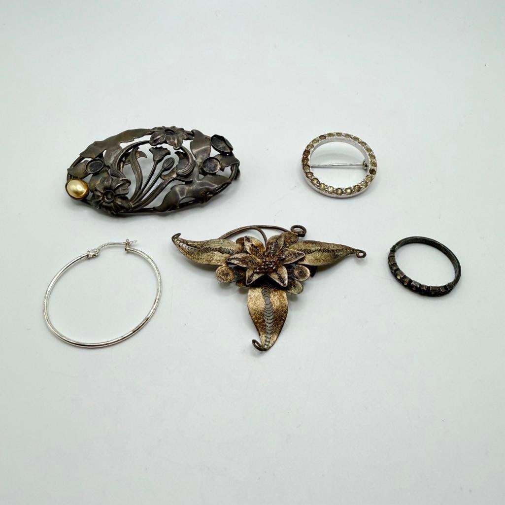 Vintage Mixed Silver Jewelry Lot: Vintage Mixed Silver Jewelry Lot Mixed lot of sterling jewelry with a single hoop earring, two brooches, a filigree pendant and ring. The circular brooch is missing two cz stones and the flower brooch