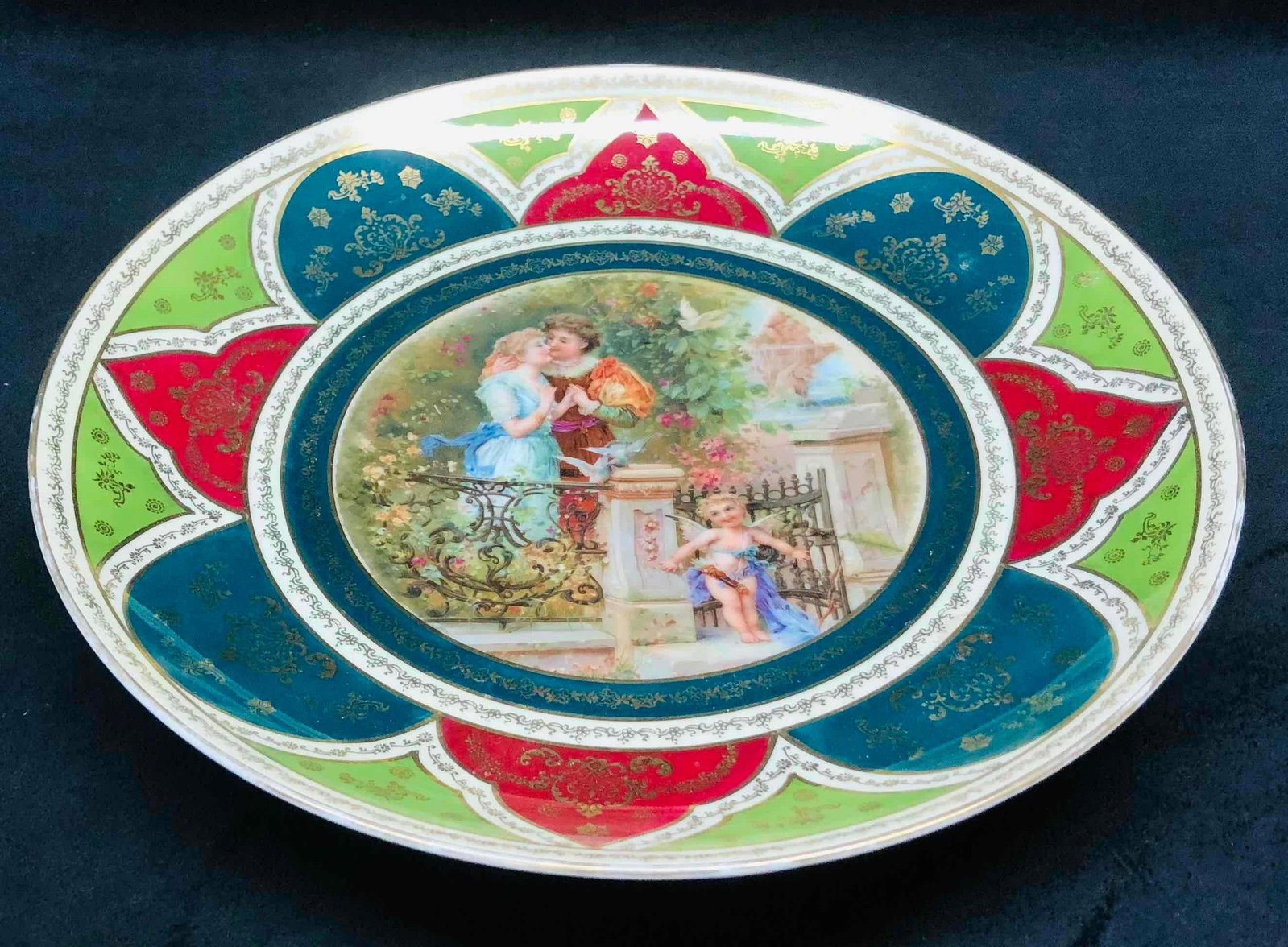 Royal Vienna Large Porcelain Wall Hanging Plate From Austria: This lot contains a Royal Vienna Large Porcelain Wall Hanging Plate From Austria. It is approx 11 3/4" x 11 3/4" x 1 3/4" and it weighs about 0.7lbs. Overall the Plate is in good used condition with