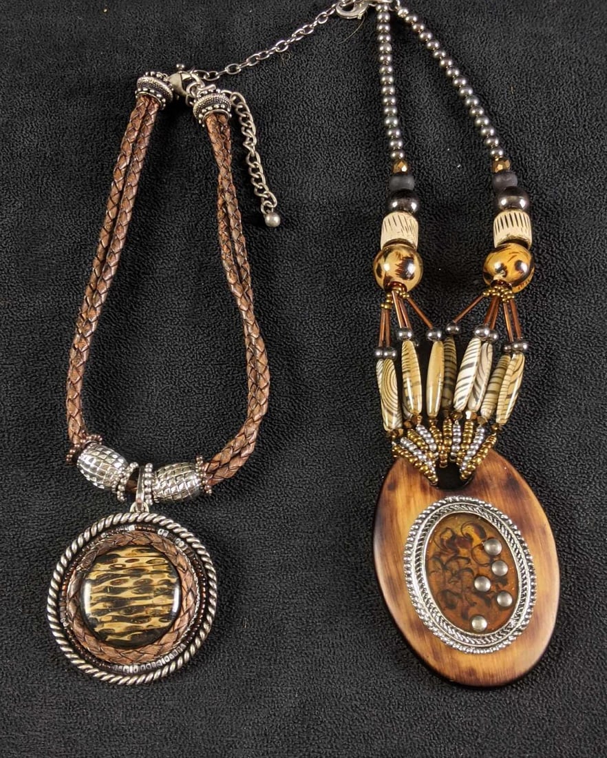 Earth Toned Necklaces With Large Pendants: Earth Toned Necklaces With Large Pendants This lot comes with two necklaces One necklace is from Chico's and the other is not branded. These two have a similar color scheme so we paired them toget