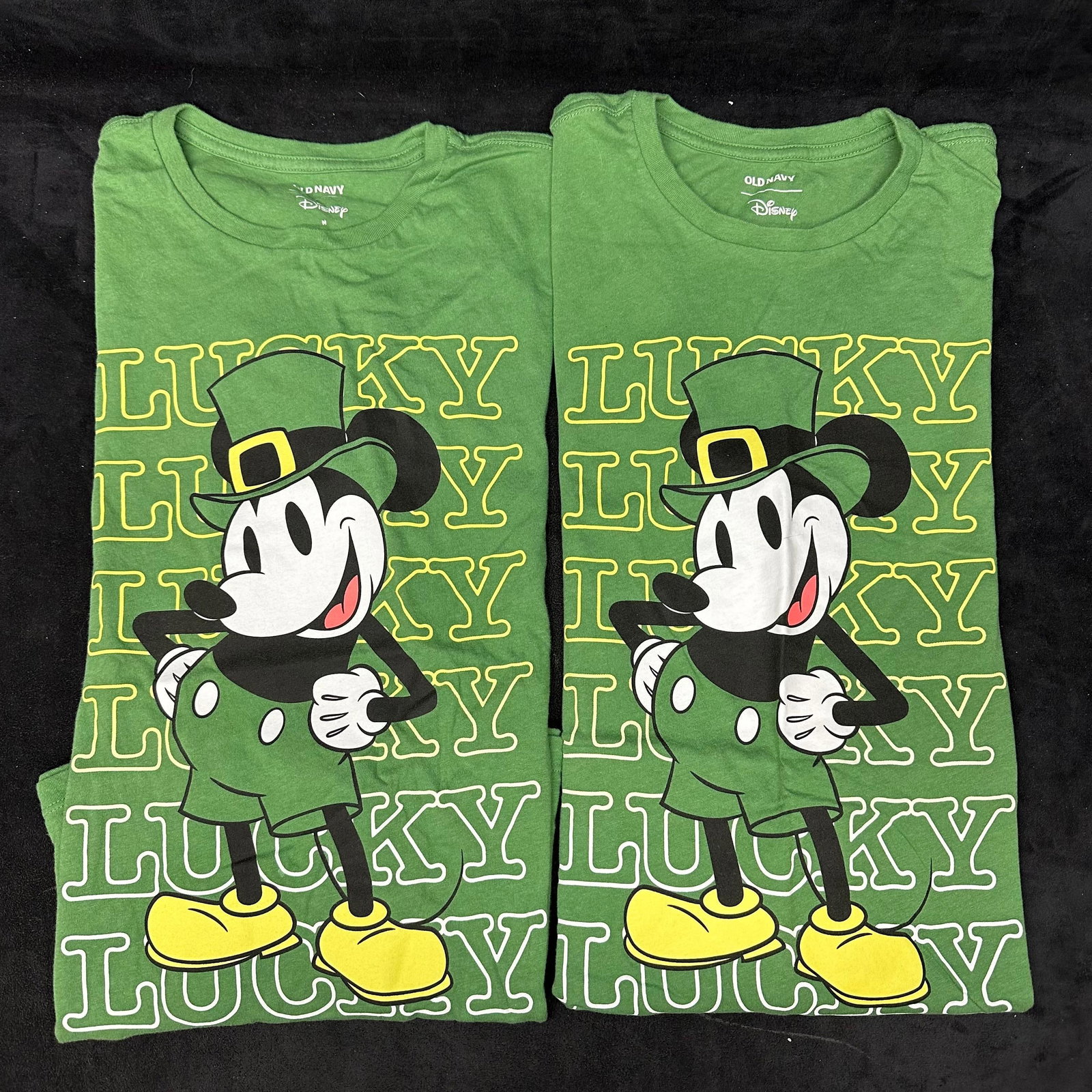 Two Old Navy Disney Mickey Mouse St. Patrick's Day Lucky T-Shirts Green Medium: A lot of two Old Navy Disney-licensed Mickey Mouse holiday Medium T-shirts featuring a festive Saint Patrick's Day design. These items are in pre-owned, previously displayed condition with light w
