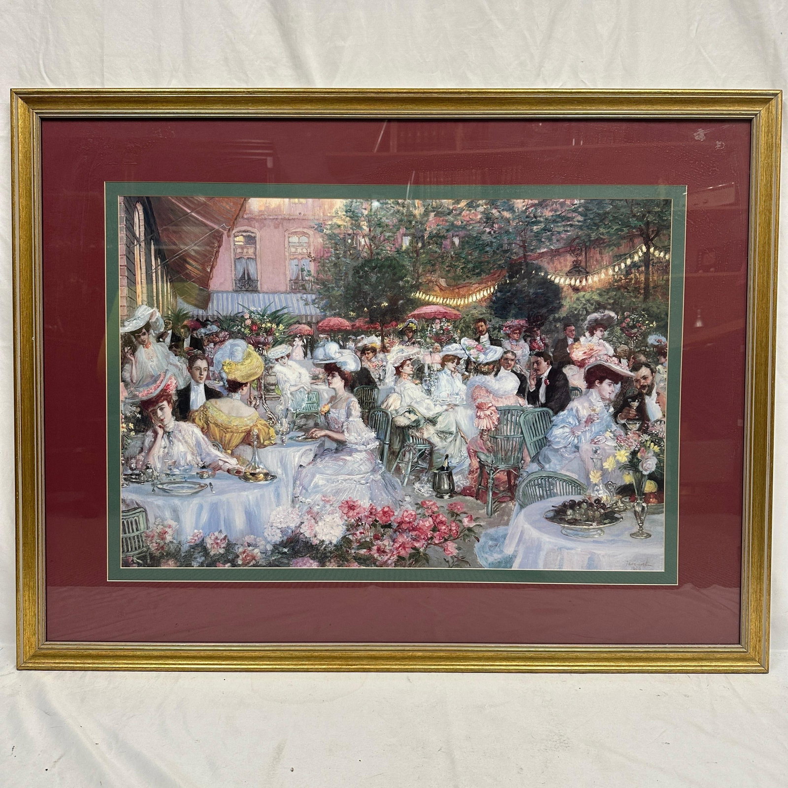 Framed After Outdoor Dinner Party Scene French Style Reproduction Print R235: Medium framed decorative reproduction print after an impressionist-style cafe scene in a French-style, depicting elegantly dressed figures dining outdoors in a bustling garden terrace setting. Print s