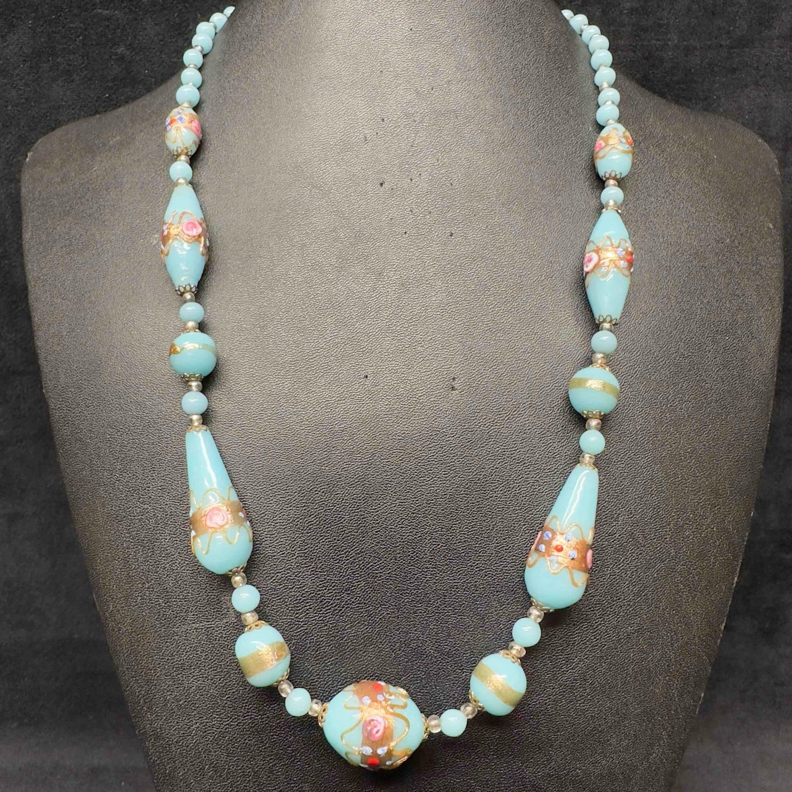 Murano Venetian Lamp Work Art Glass Light Blue Copper Colored Floral Pink Beaded Necklace F50: Murano Venetian Lamp Work Art Glass Light Blue Copper Colored Floral Pink Beaded Necklace F50. Necklace with light blue colored glass beads with a beautiful design on each. The necklace features pink 