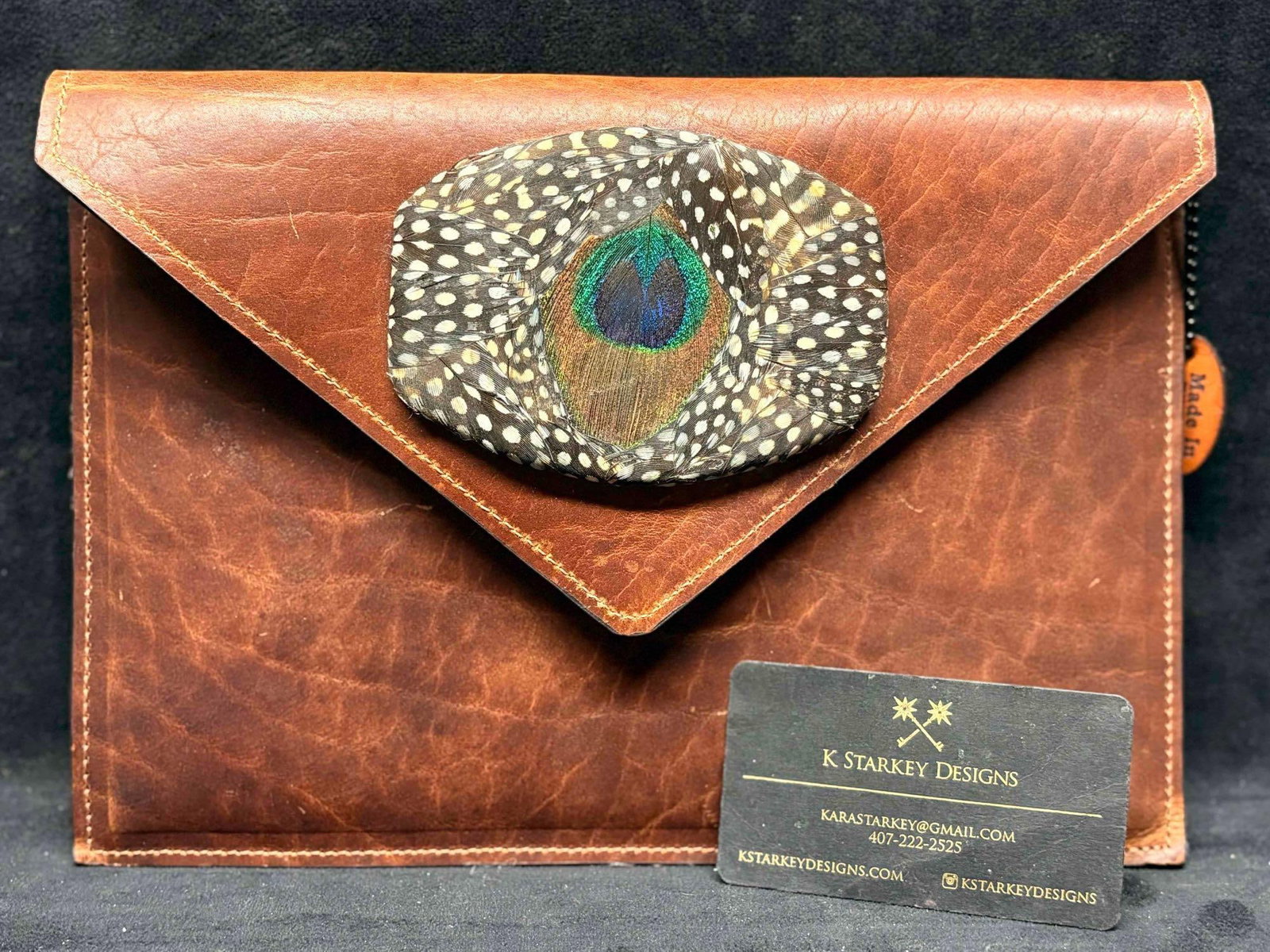 1980s Brown Leather Clutch or Crossbody with Peacock Feather Accents: This lot includes a versatile brown leather purse from K Starkey Designs and Red Sky Designs. Made of real leather and peacock feathers, this clutch offers you the option of attaching a strap and tran