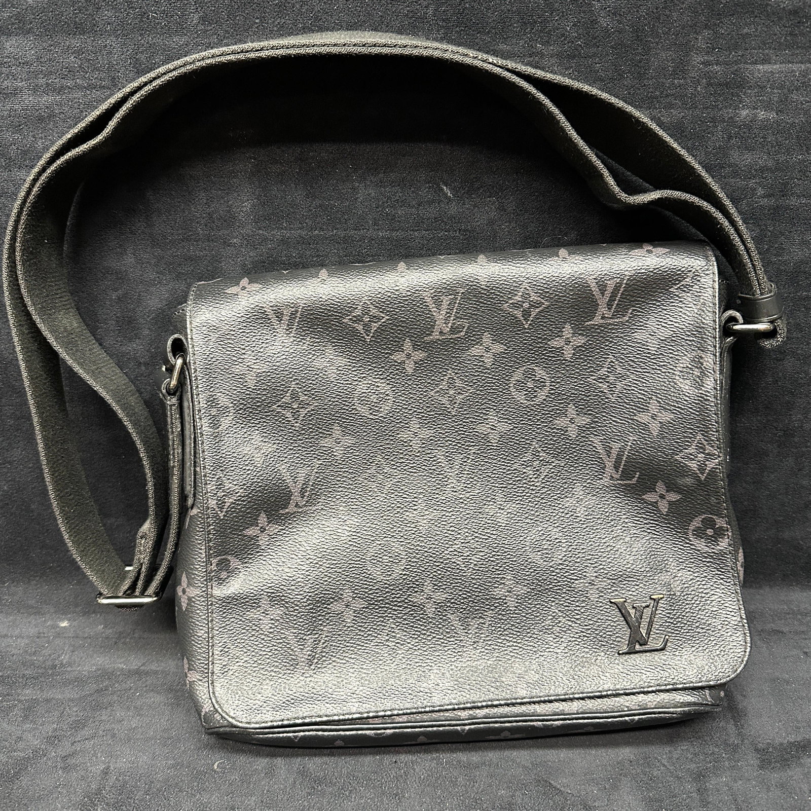 Louis Vuitton District Messenger Bag PM Black Canvas Monogram Eclipse: Black monogram messenger style shoulder bag in the manner of Louis Vuitton featuring an all-over LV-style pattern, flap front, adjustable shoulder strap, and interior “Louis Vuitton Paris Made