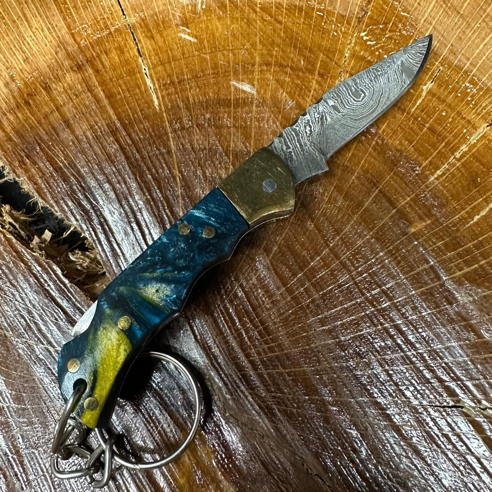 MHS Cutlery Keychain Steel Folding Blade Pocket Knife R51: Small folding-blade pocket knife featuring a steel blade and a compact epoxy-resin/wood handle secured with brass pins. Includes an attached metal key ring for easy carry. Good like-new condition with