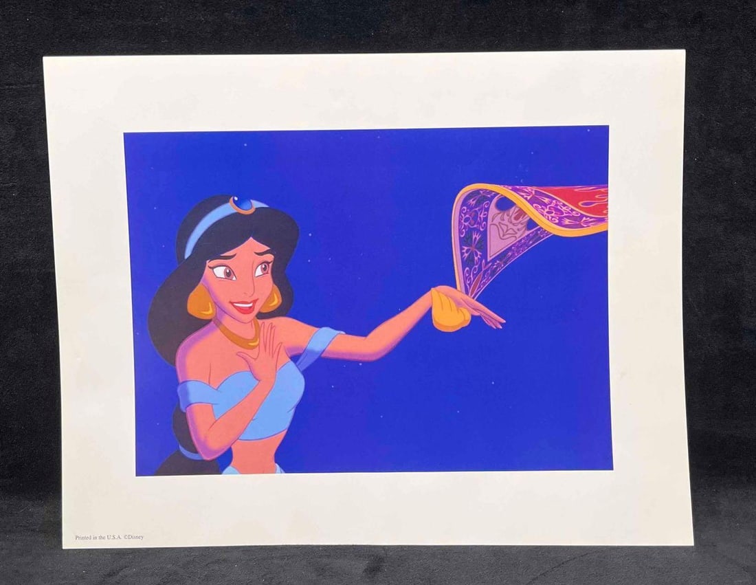 Disney's Aladdin Exclusive Commemorative Lithograph 2004 (A): This lot contains a Disney's Aladdin Exclusive Commemorative Lithograph 2004 (A). This Lithograph features Jasmine and the Magic Carpet. Aladdin is a 1992 Animated musical film produced by Walt Di