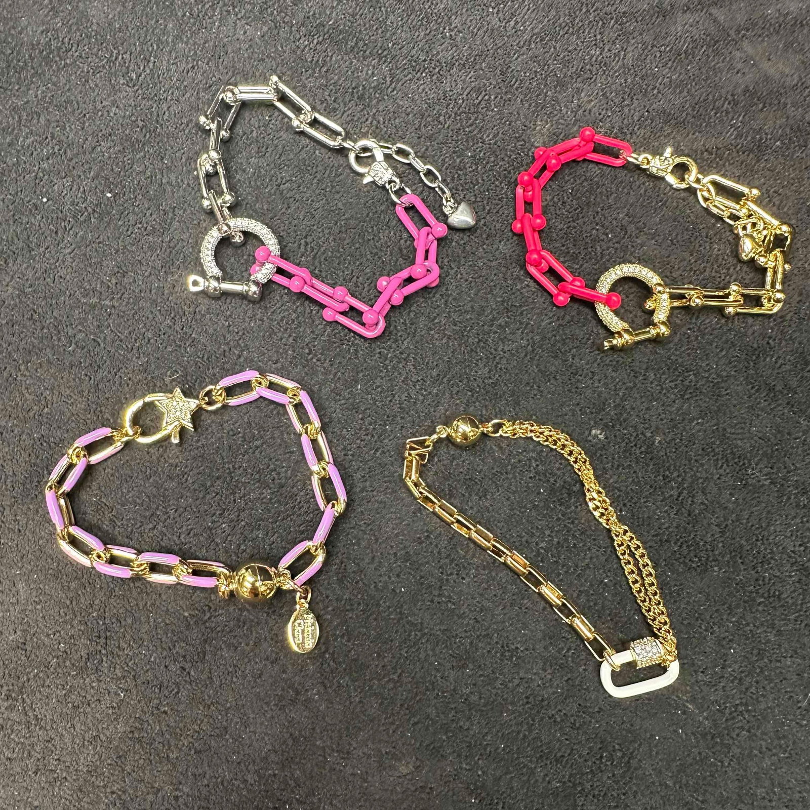 Melania Clara Gold Tone Chain Mixed Bracelet Set Modernist Style: The Melania Clara bracelet set features a magnet or lobster claw clasp closure. Each bracelet showcase modernist designs with a gold toned chains and rhinestones and heart accents. These items are in 