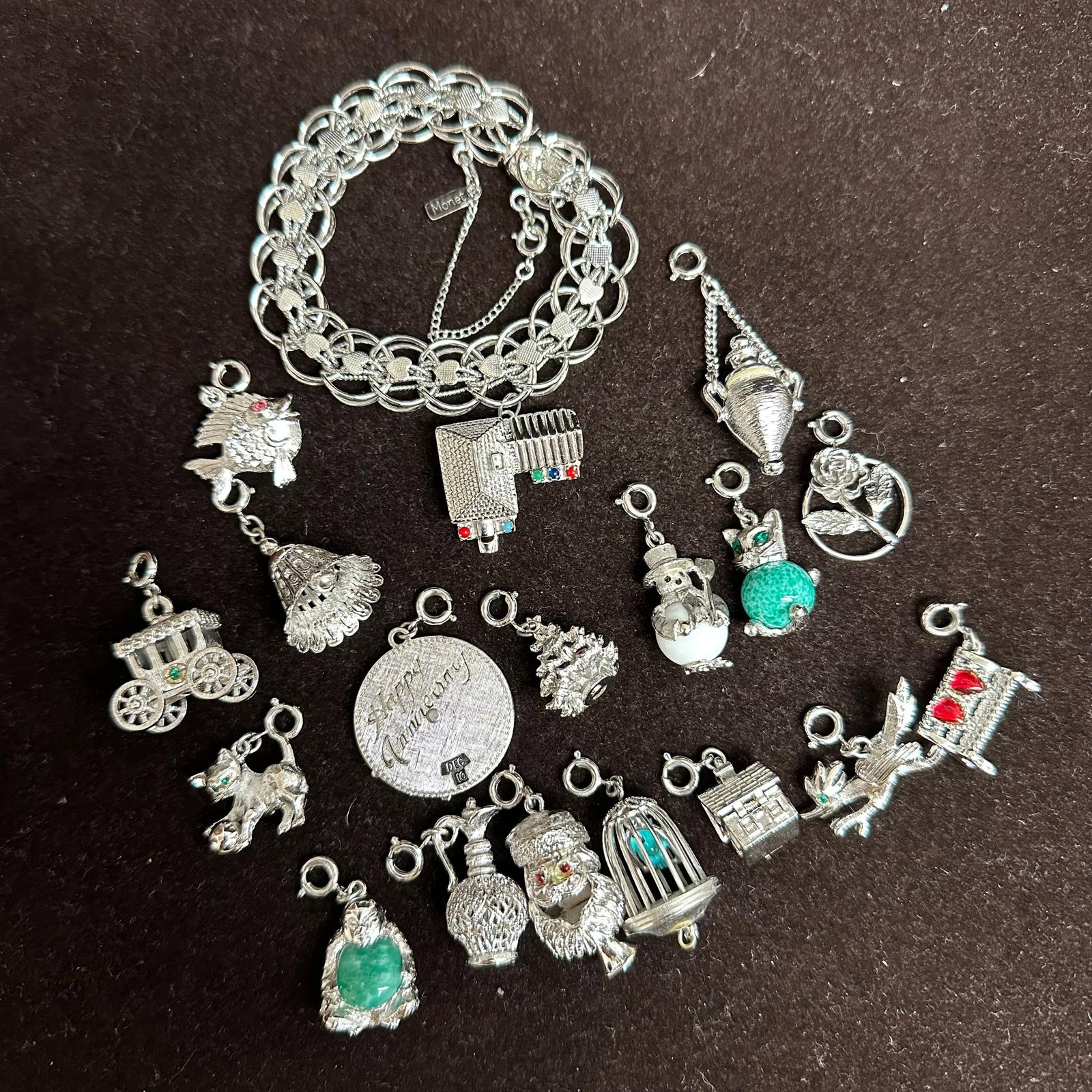 Vintage Silver Tone Monet House Charm Bracelet with 17 Interchangeable Charms: Vintage Monet silver-tone charm bracelet with safety chain and lobster clasp. Marked ?Monet? on bracelet tag. Includes 17 interchangeable Monet charms plus one fixed charm attached to the bracelet. Th