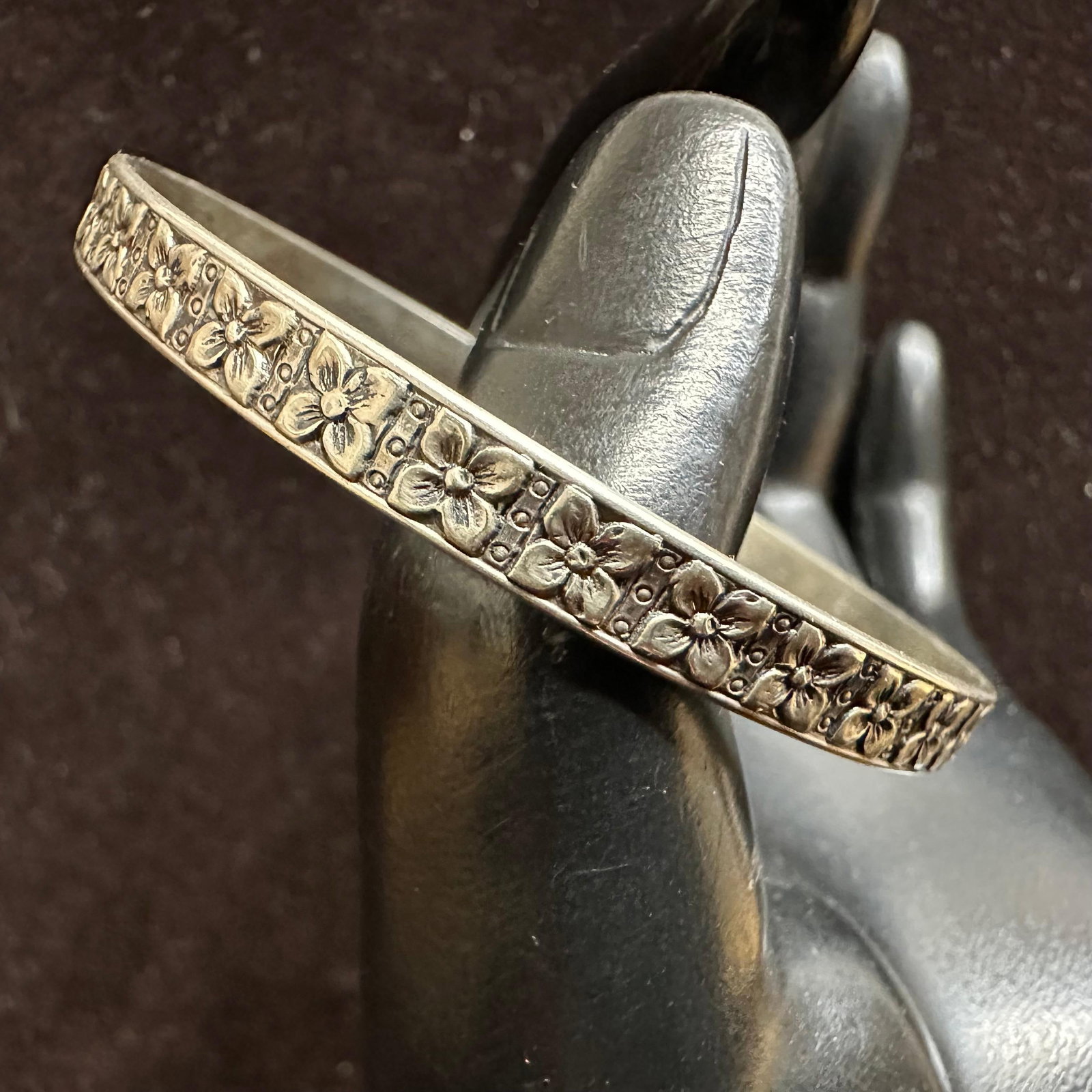 Art Deco Style Repeating Embossed Floral Motif Sterling Bangle Bracelet: This item is in good pre-owned, previously used/displayed condition with noticeable light wear and surface scratches. Please reference all photos for full details. This piece of jewelry has been