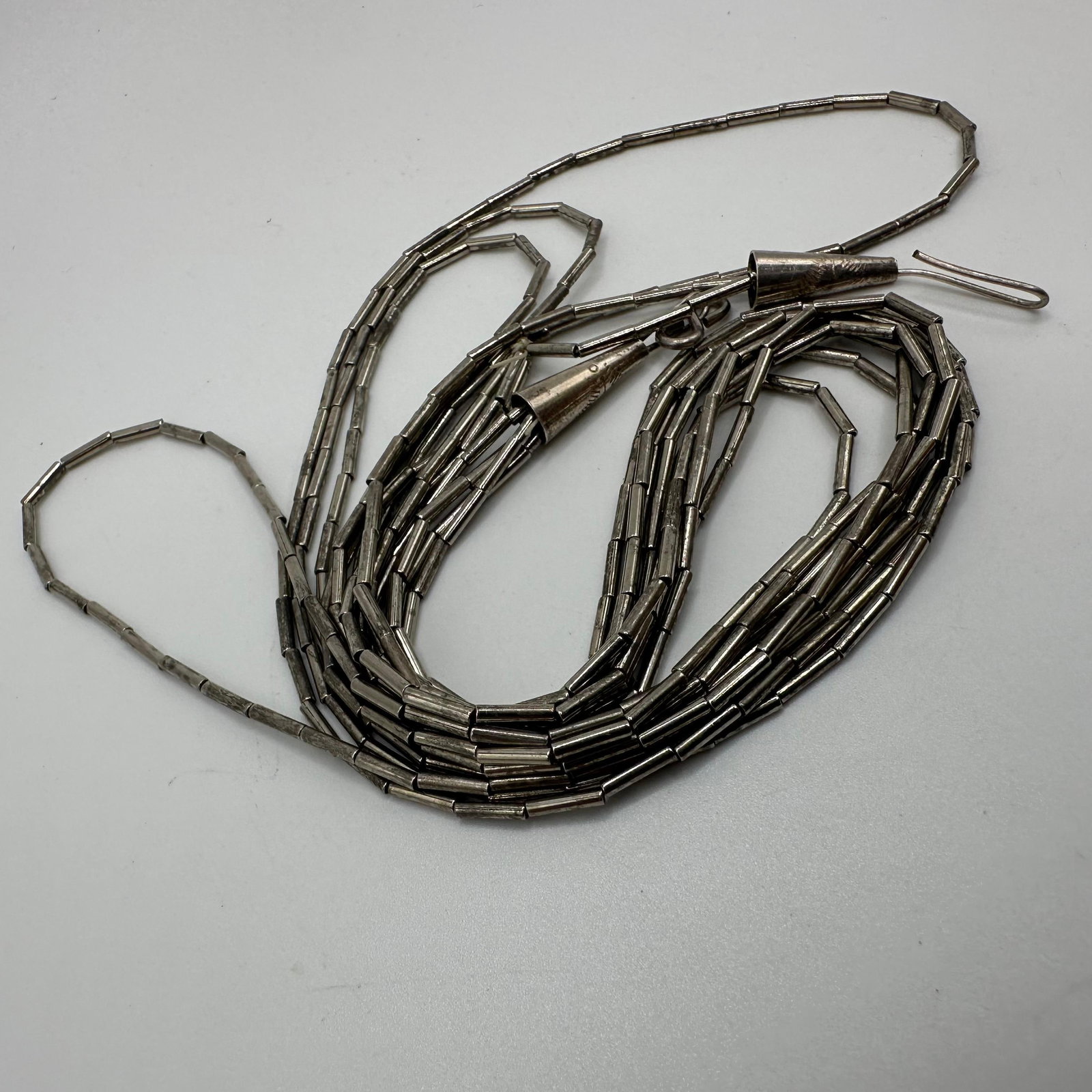 Liquid Silver Style Unmarked Four Strand Necklace X37: This item is in good pre-owned, previously used/displayed condition with noticeable light wear and surface scratches. Please reference all photos for full details. This piece of jewelry has been teste