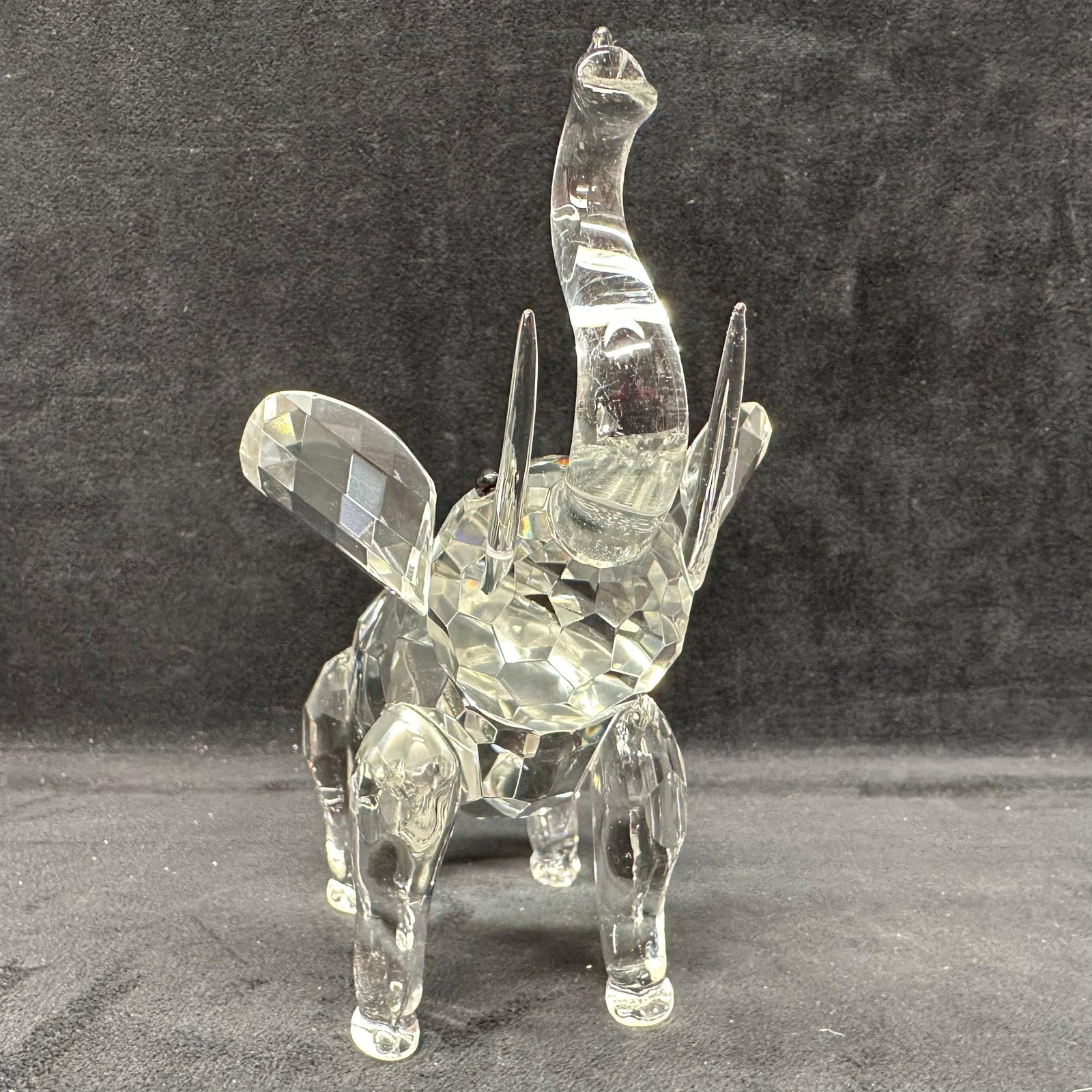 Shannon Crystal Elephant Sculpture by Godinger Glass Art Figure: Faceted clear crystal elephant sculpture by Shannon Crystal for Godinger. Includes original box and care cards. The elephant features a raised trunk and a detailed cut crystal design. The box shows